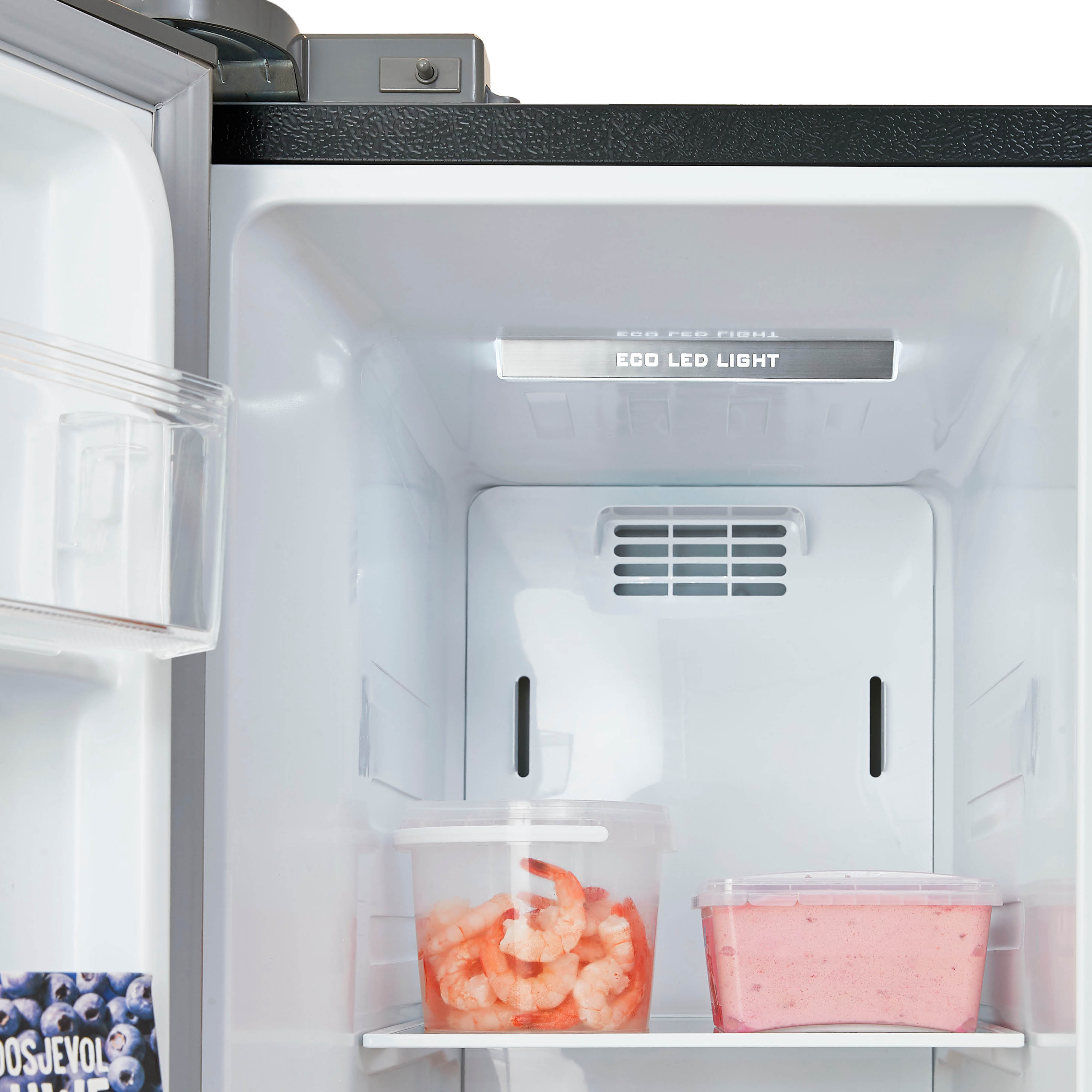 Refrigerator interior with shrimp and pink food containers under a light.