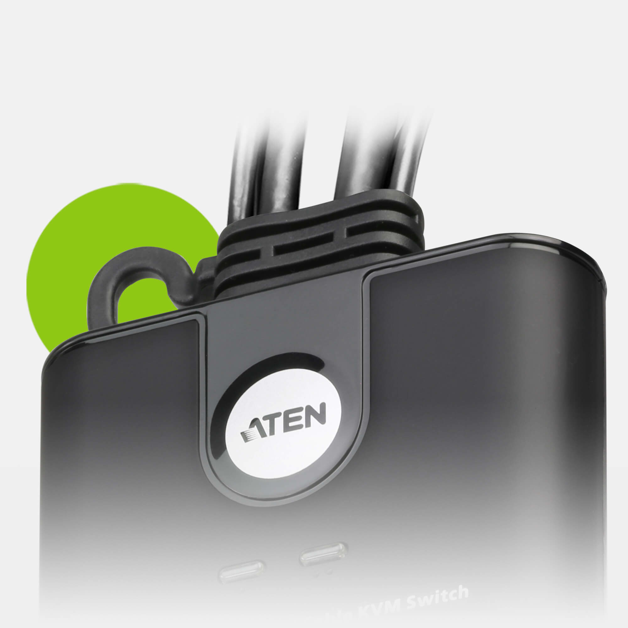 Close-up of a black device with the ATEN logo, green circle highlight, and cables.