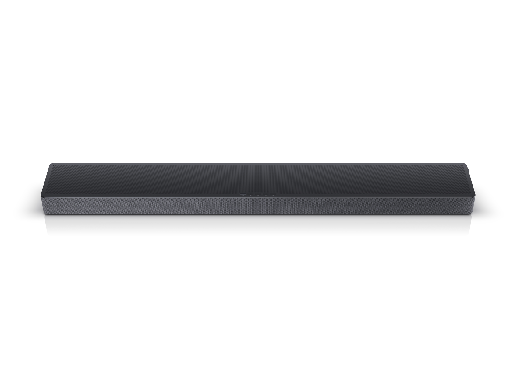 Eine schwarze Soundbar mit einem Mesh-Front. Sie ist rechteckig, lang und steht auf einer weißen Oberfläche.