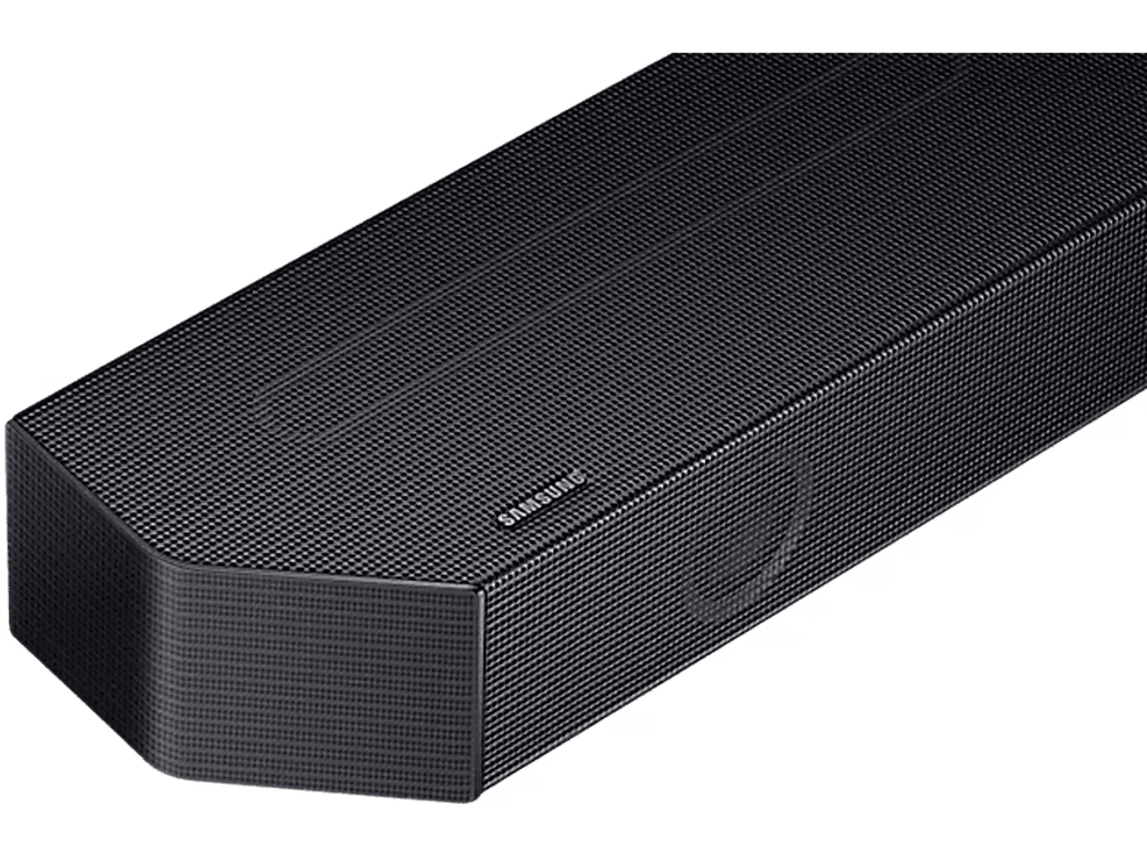 Barra de sonido negra con superficie texturizada, logo Samsung, sobre fondo negro.