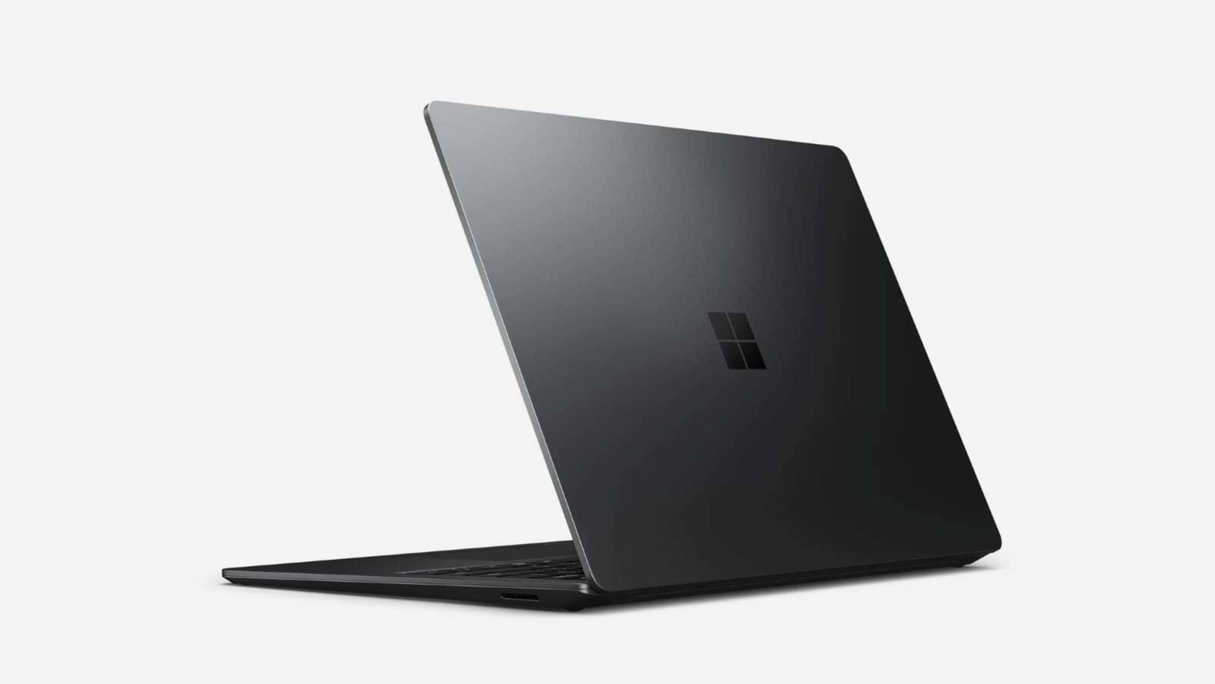 Schwarzer Laptop, Rückansicht, auf weißem Hintergrund. Microsoft-Logo in der Mitte. Schlankes, minimalistisches Design.