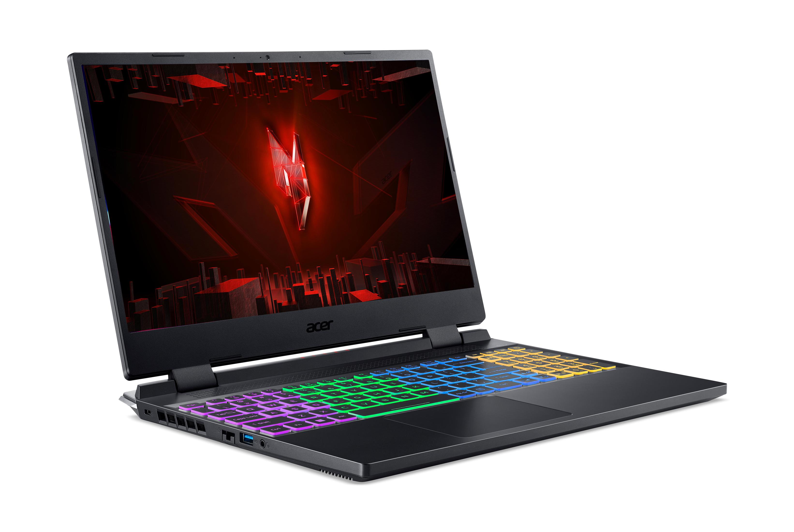 Schwarzer Laptop mit bunter Tastatur liegt auf weißer Oberfläche.