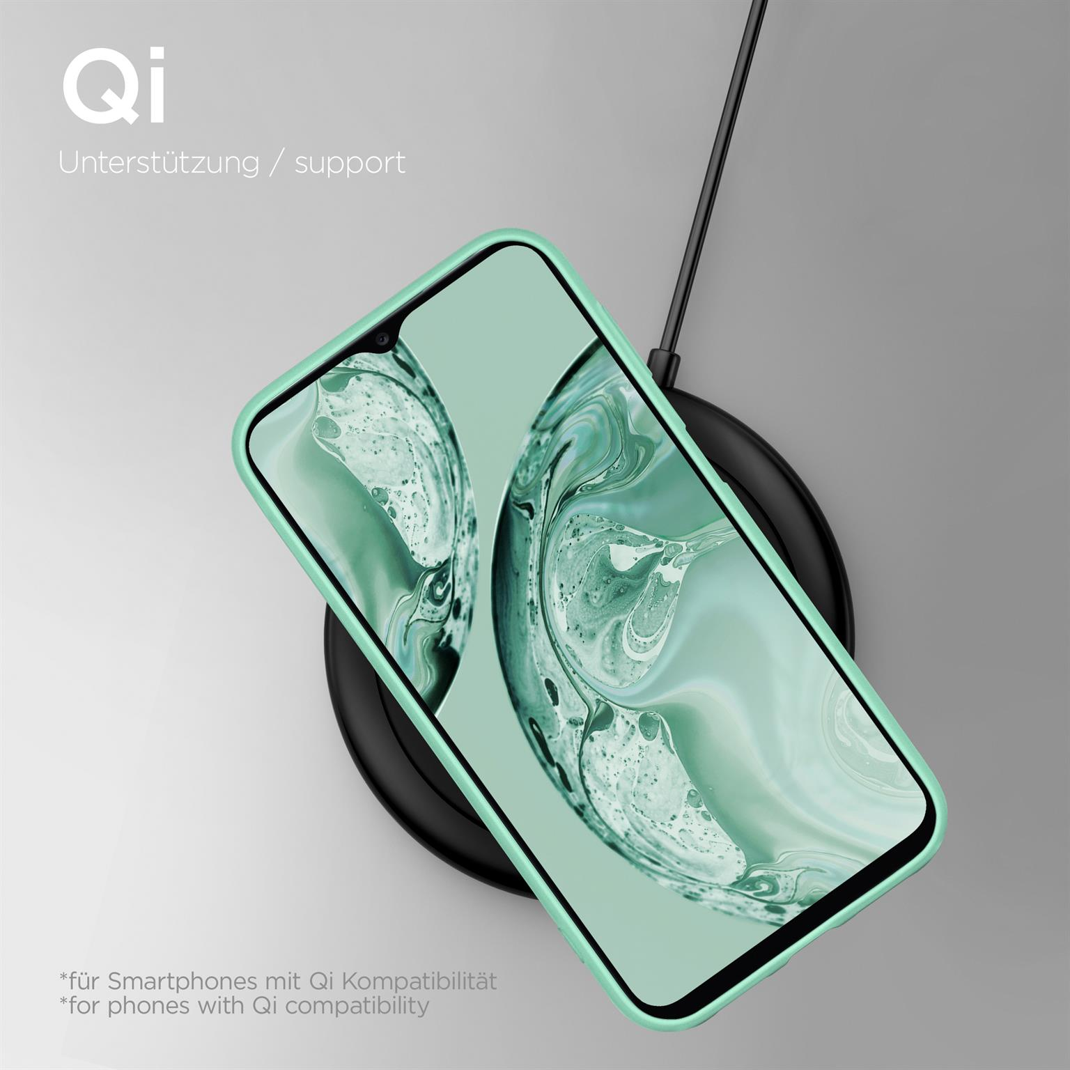 Eine mintgrüne Handyhülle auf einem kabellosen Ladegerät, mit einem Telefon darin.