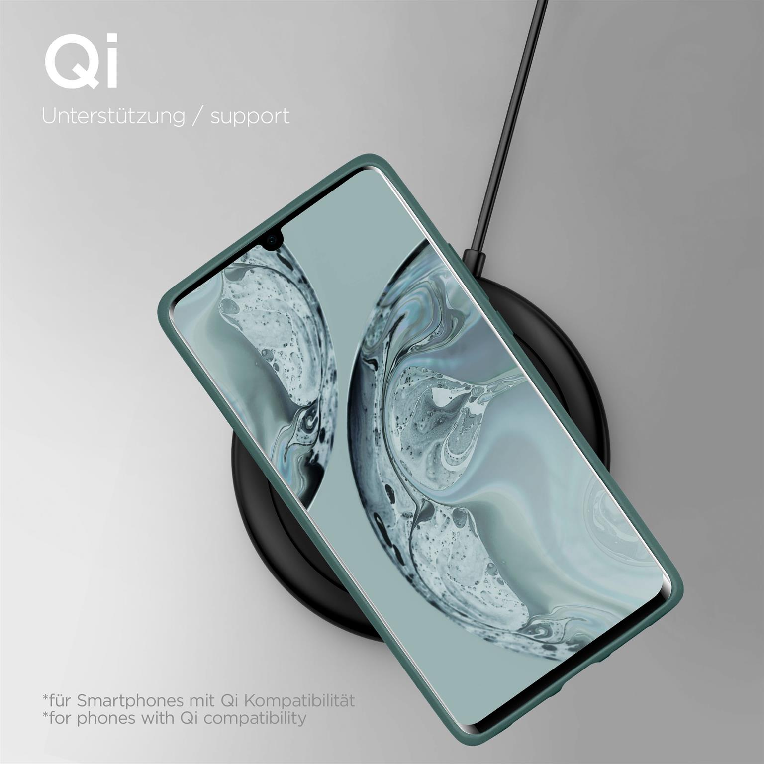 Ein Telefon in einer grünen Hülle liegt auf einem kabellosen Ladegerät. Text: Qi-Unterstützung. Hintergrund hellgrau.