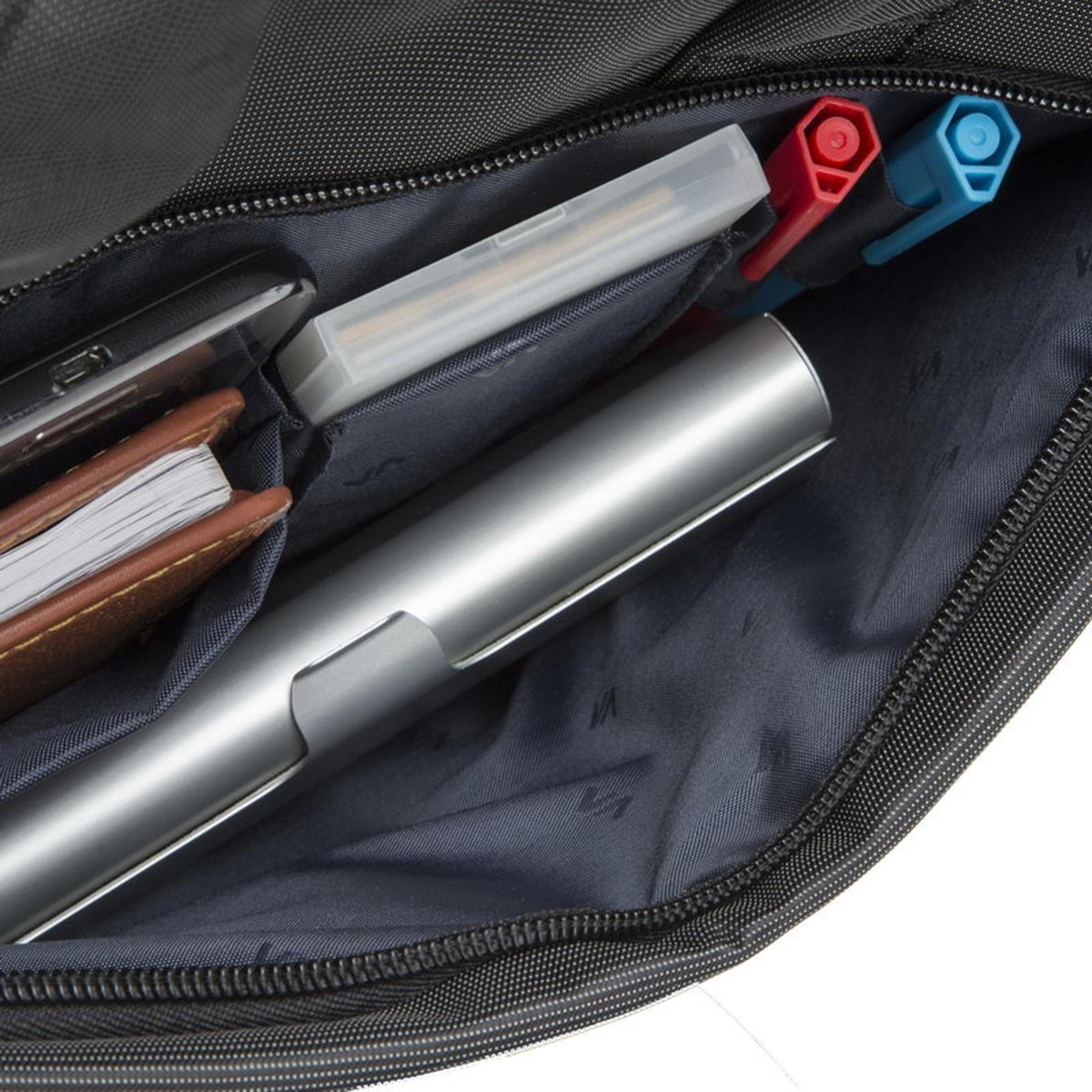 Inside a black bag: pens, notepad, phone, and a silver pen. Dark interior.