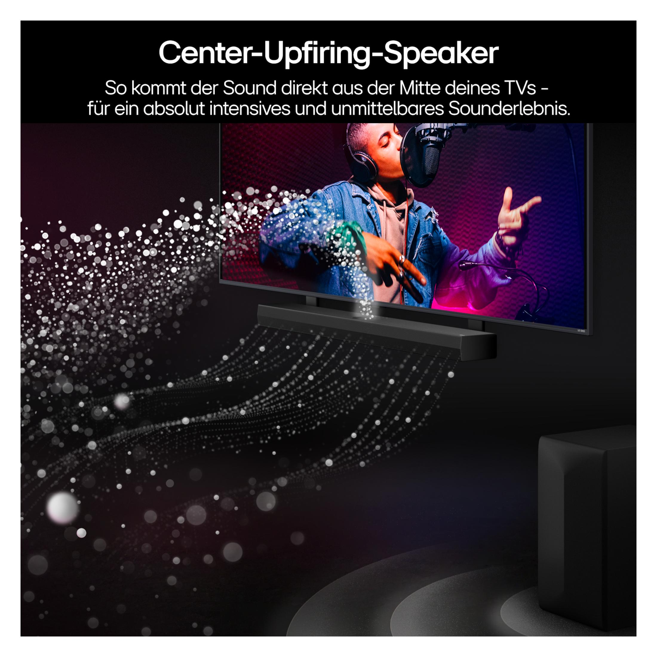 Telewizor pokazuje piosenkarza na scenie. Głośnik jest zamontowany pod telewizorem.