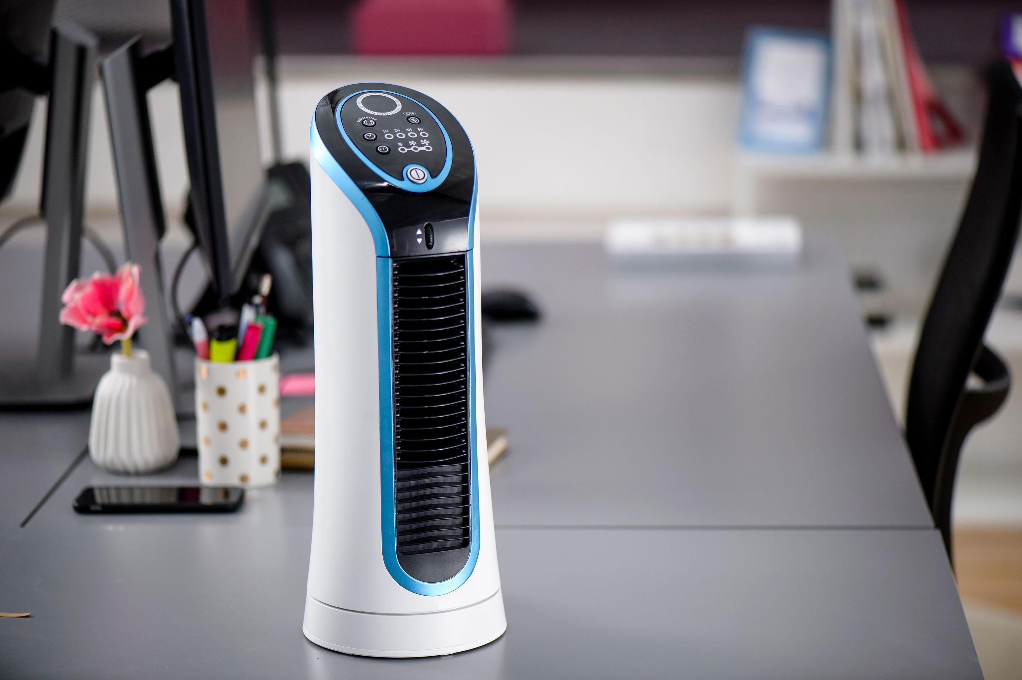 Biało-niebieski wentylator wieżowy na biurku w otoczeniu biurowym. Wentylator ma przyciski sterujące.
