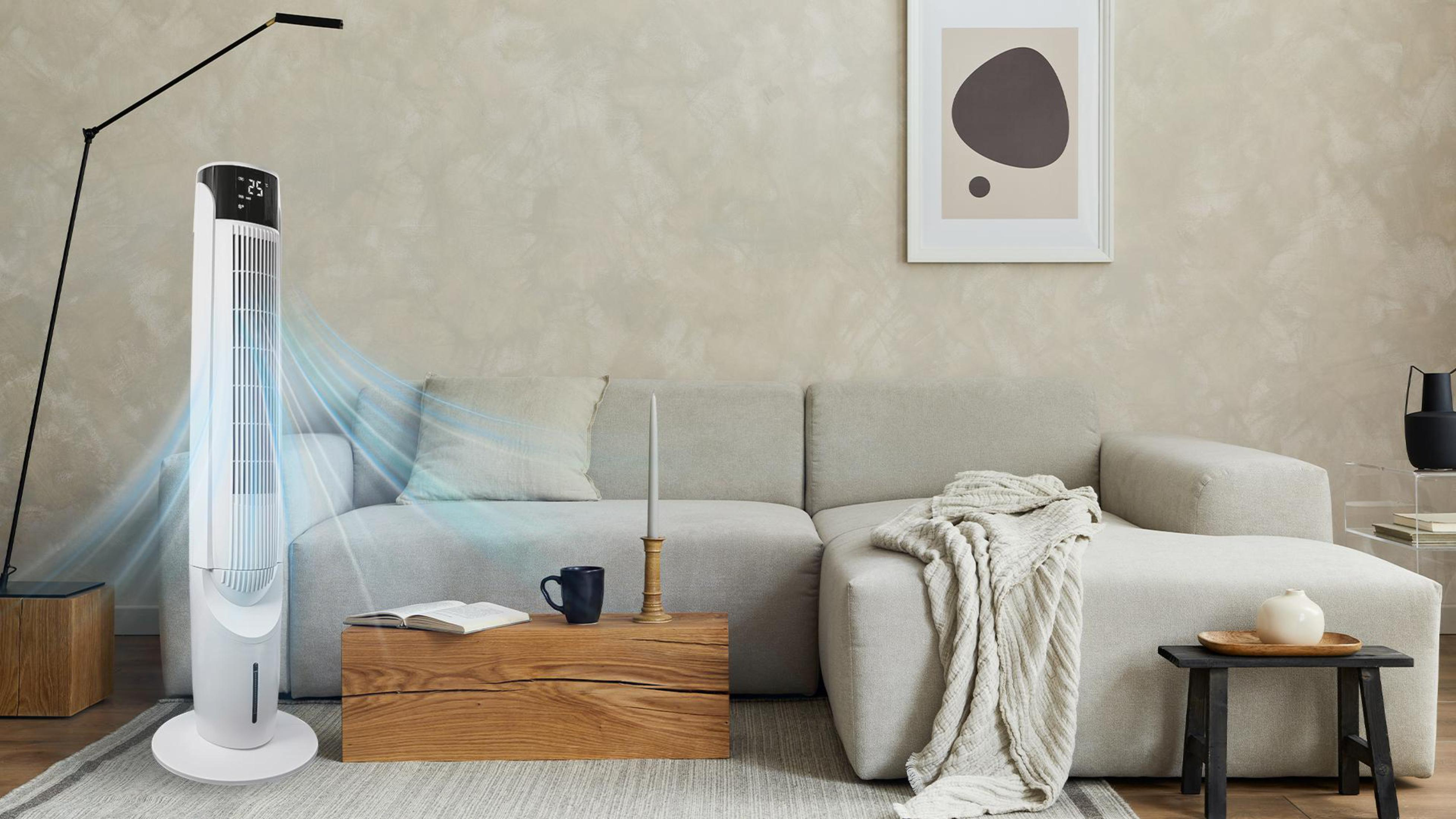 Weiß-schwarzer Luftkühler in einem Raum mit Sofa, Tisch und Dekoration.