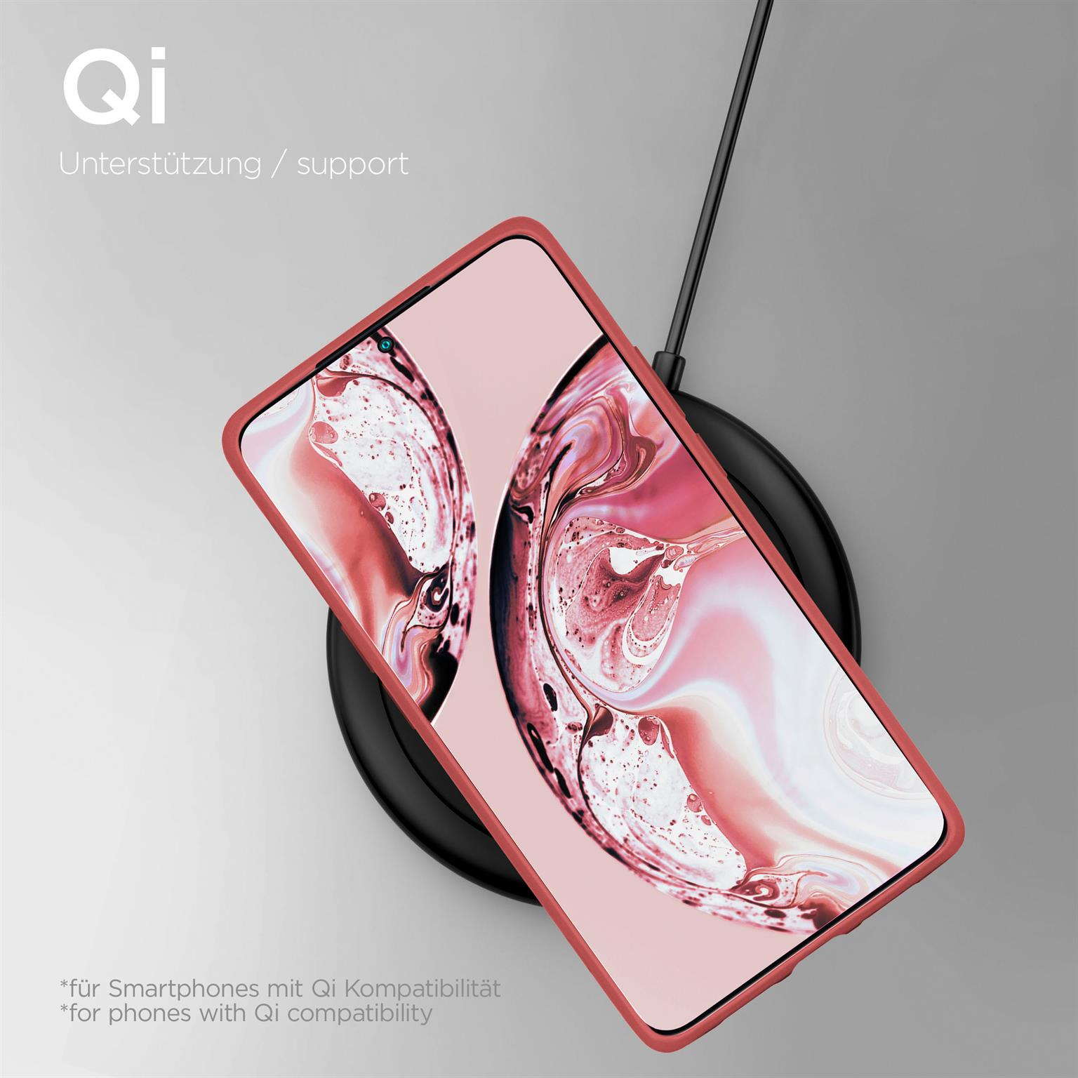 Rosa Telefon auf schwarzem kabellosen Ladegerät.