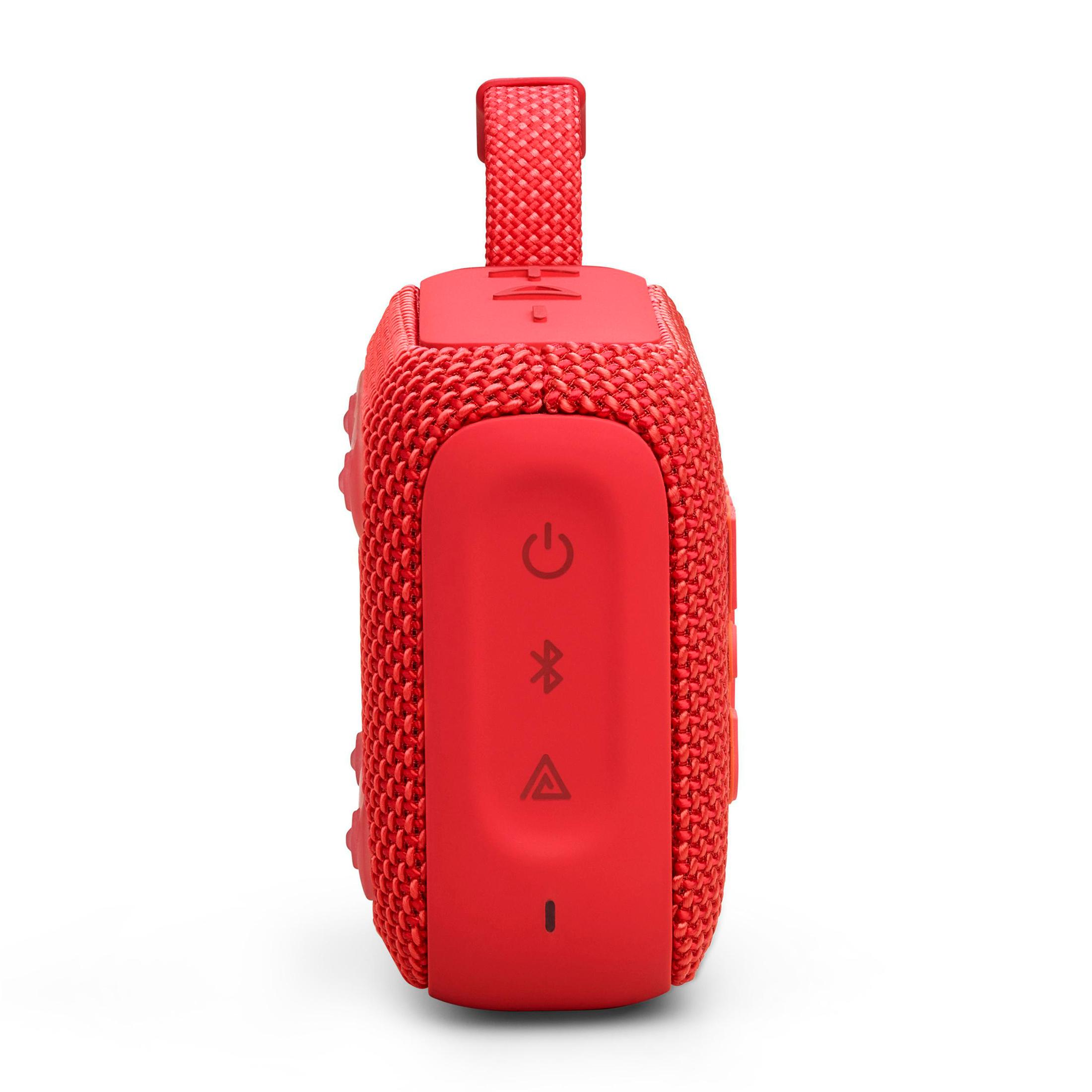 Czerwony, prostokątny głośnik z przyciskami i pętlą. Przyciski obejmują zasilanie, bluetooth i głośność.