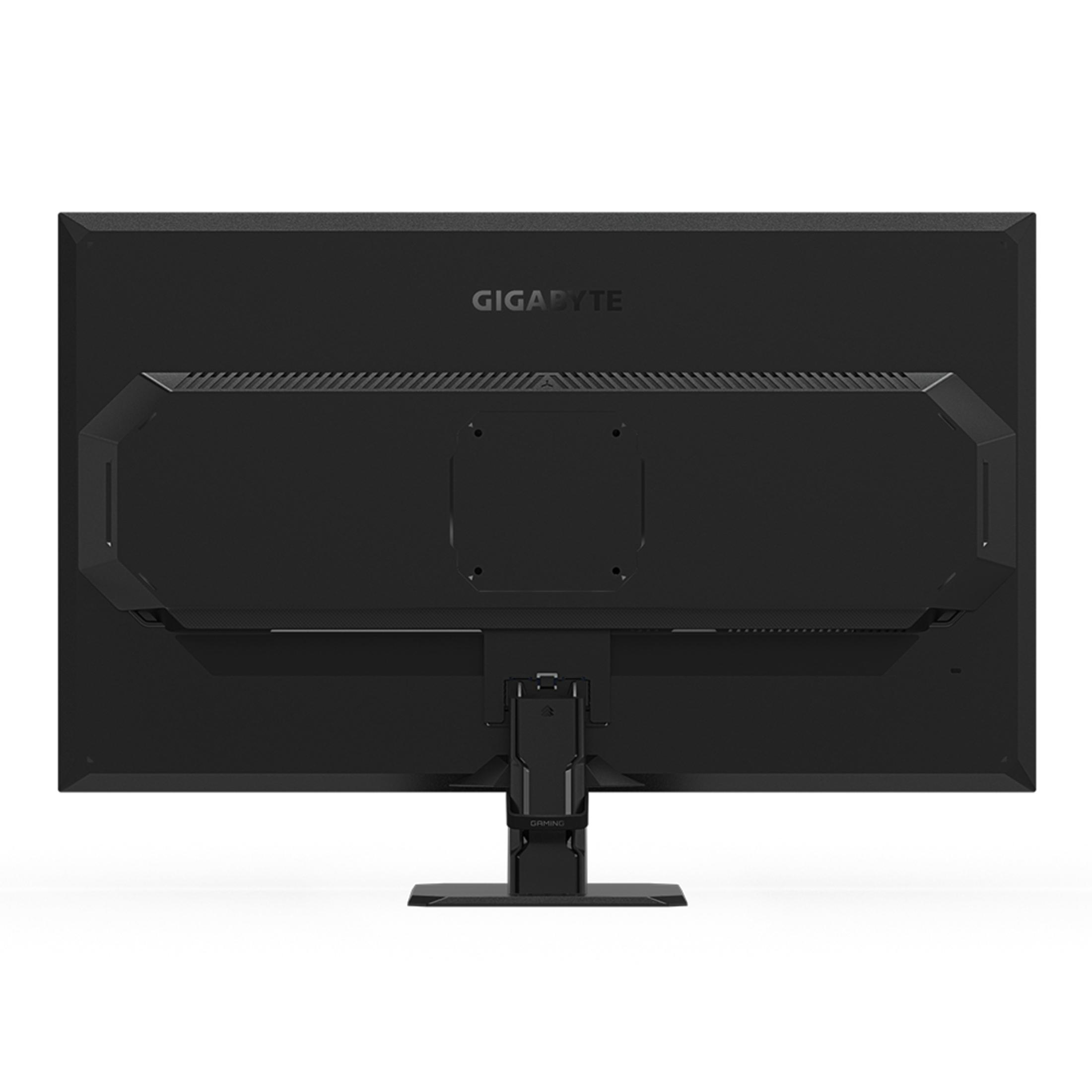 Widok z tyłu monitora Gigabyte. Czarny. Widoczny stojak i porty. Białe tło.