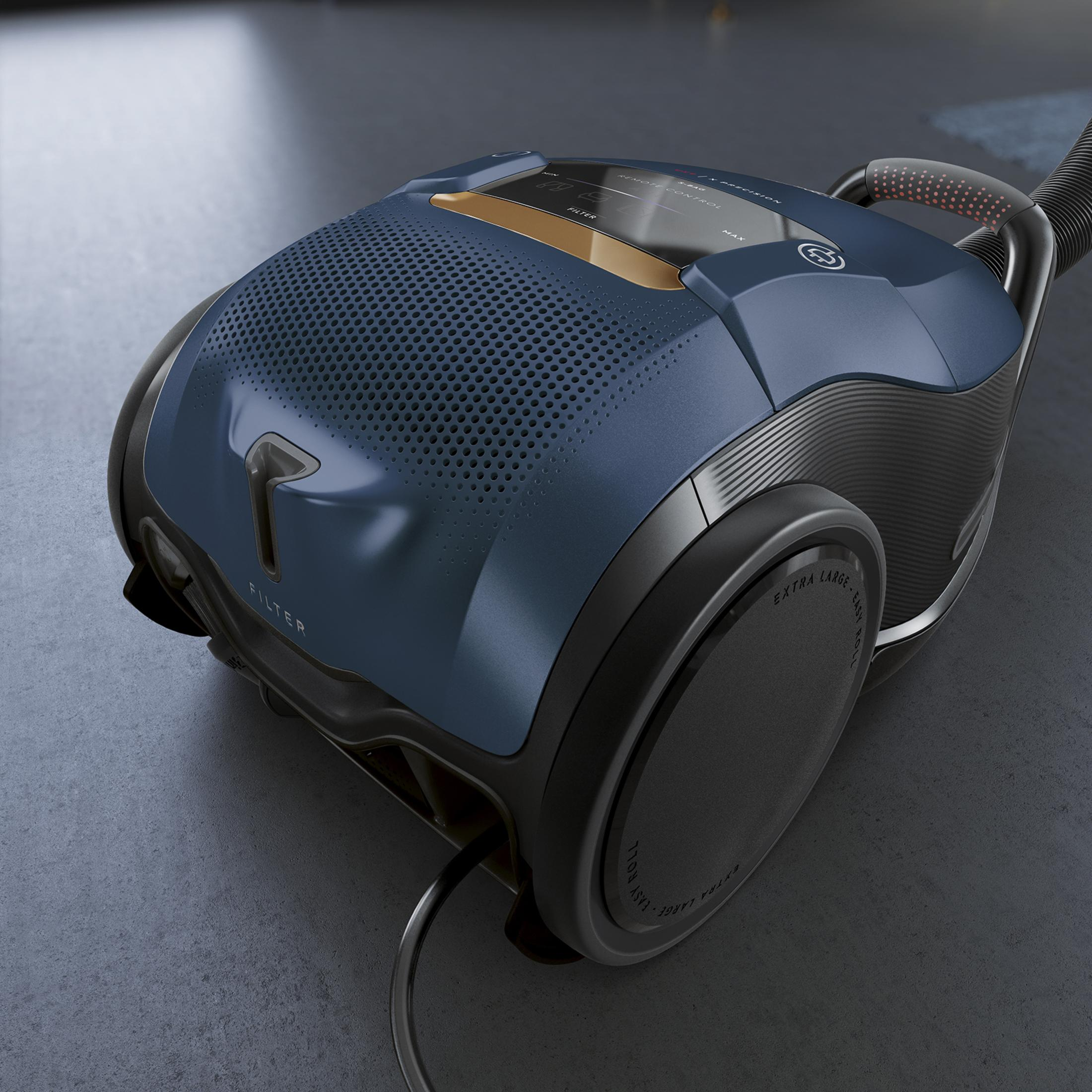 Niebiesko-czarny odkurzacz na szarej powierzchni, zakrzywiony design, czarne koła.