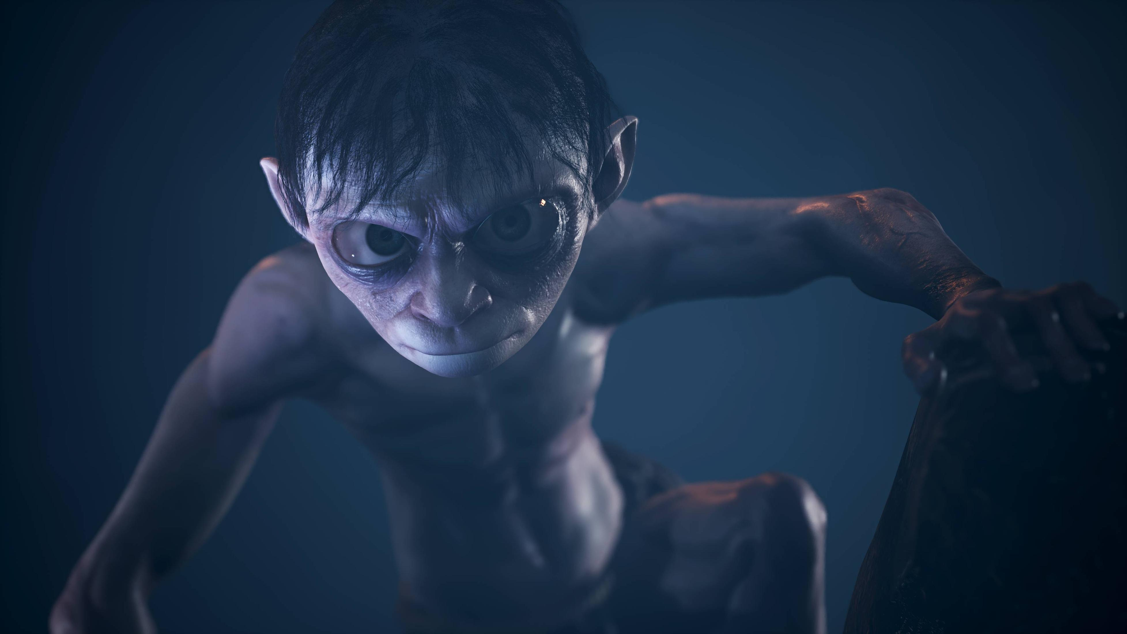Gollum aus Der Herr der Ringe. Blasse Haut, große Augen, blickt mit dunklem Hintergrund zum Betrachter.