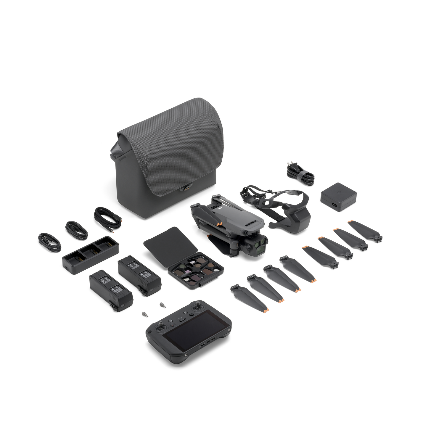 Drone e accessori disposti. Include drone, controller, custodia, lame extra, caricabatterie e altre parti.