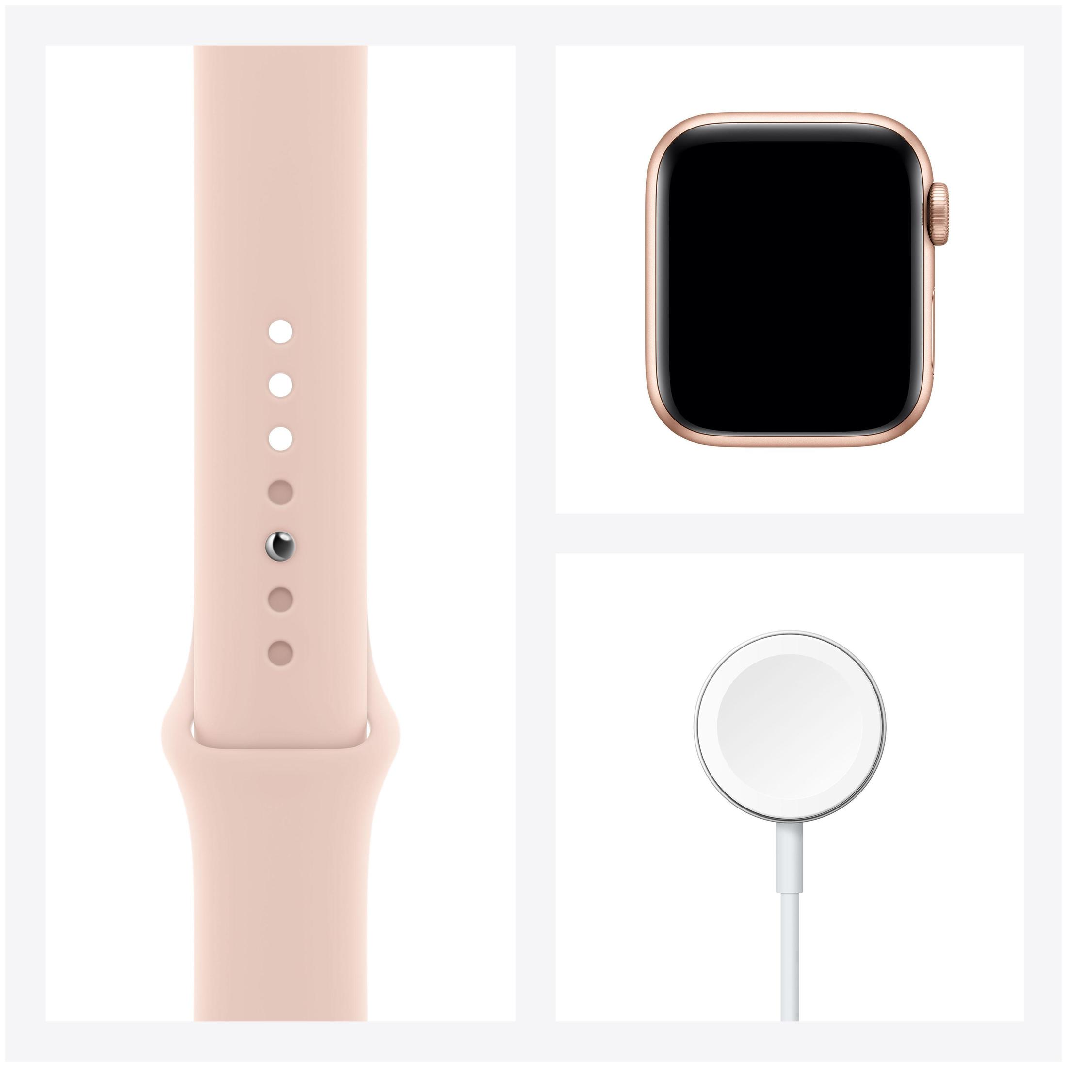 Apple Watch mit pinkfarbenem Armband und Ladegerät. Anordnung auf weißem Hintergrund.