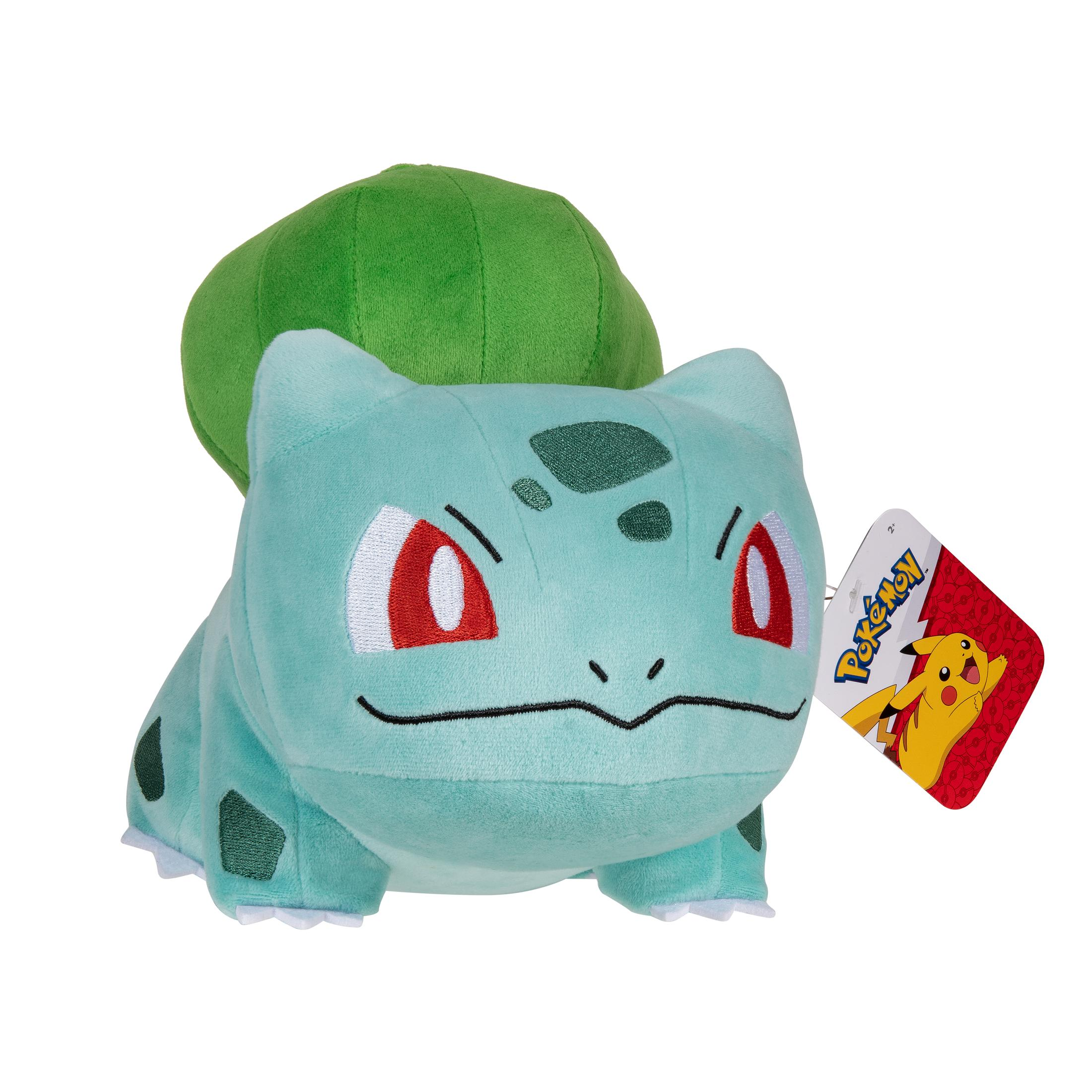 Une peluche Bulbizarre de Pokémon, verte avec des yeux rouges et une étiquette.