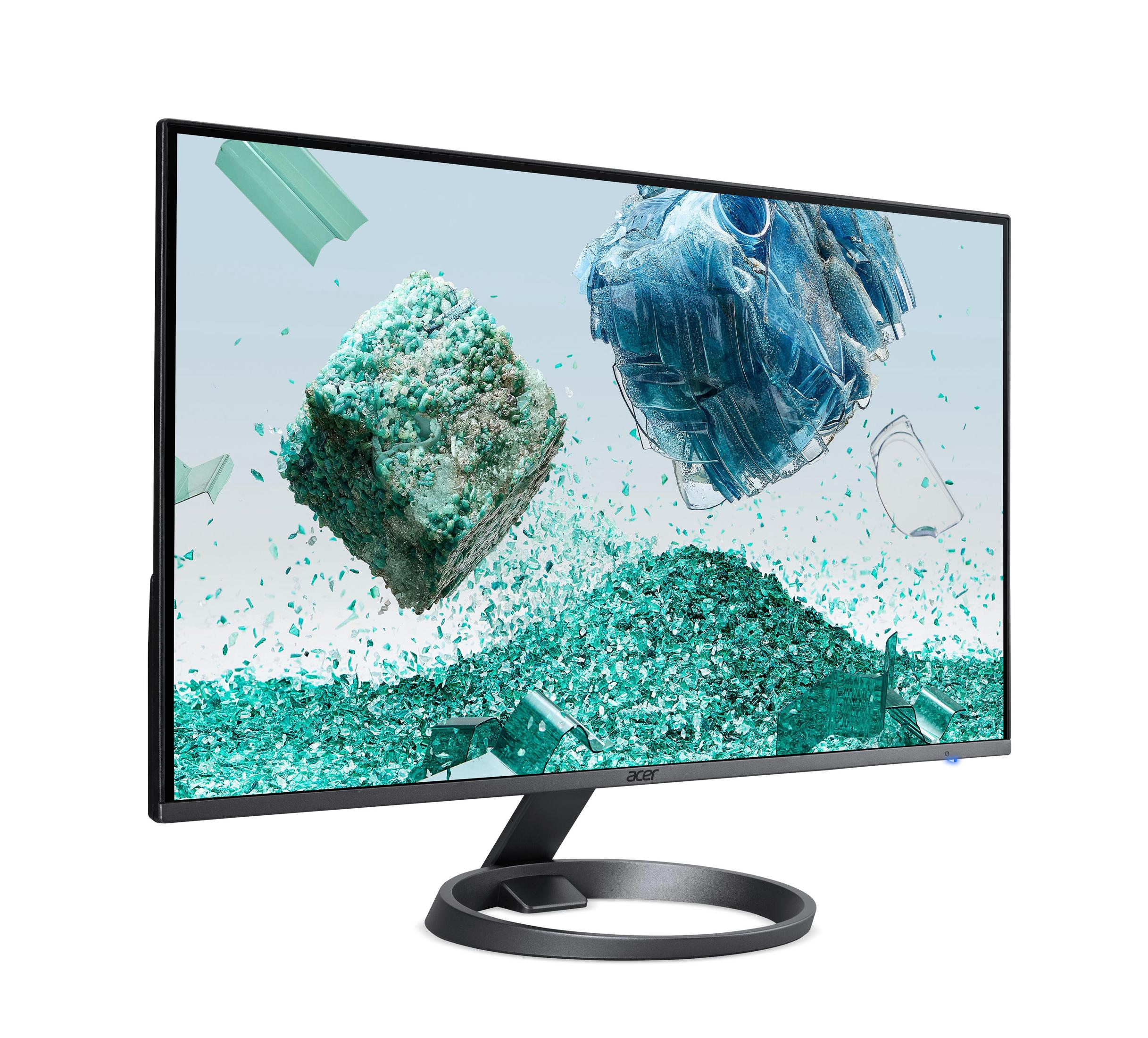 El monitor muestra formas verdes abstractas. El monitor está sobre un soporte negro.