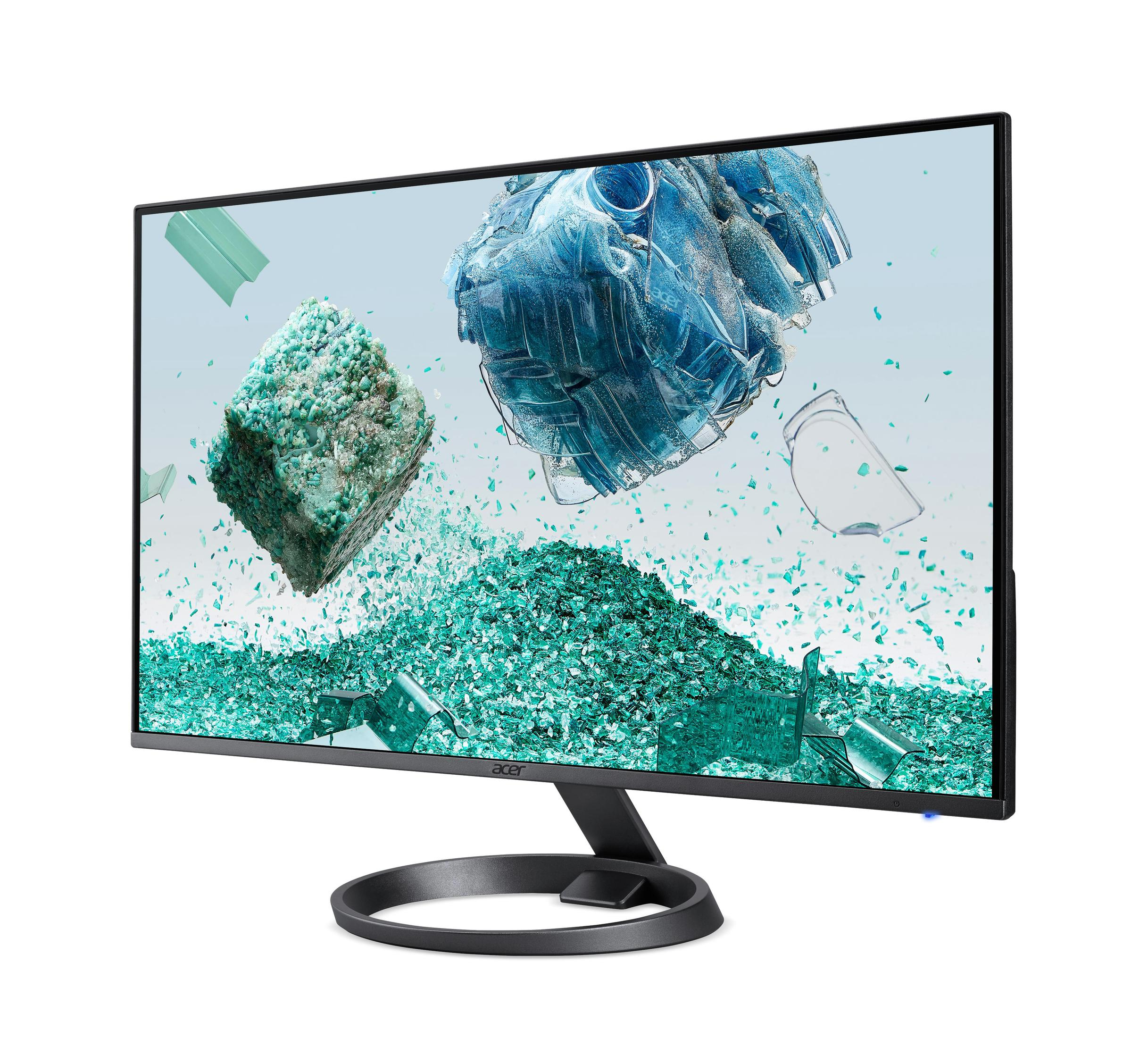 Monitor de computadora que muestra formas azules abstractas y fragmentos verdes. Fondo blanco.