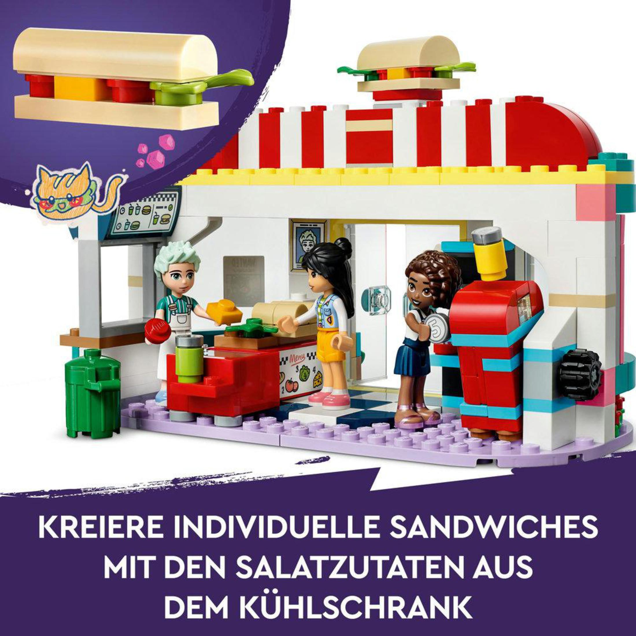 Lego-Set mit Minifiguren in einem Sandwich-Shop. Zutaten und ein Katzenaufkleber oben drauf.