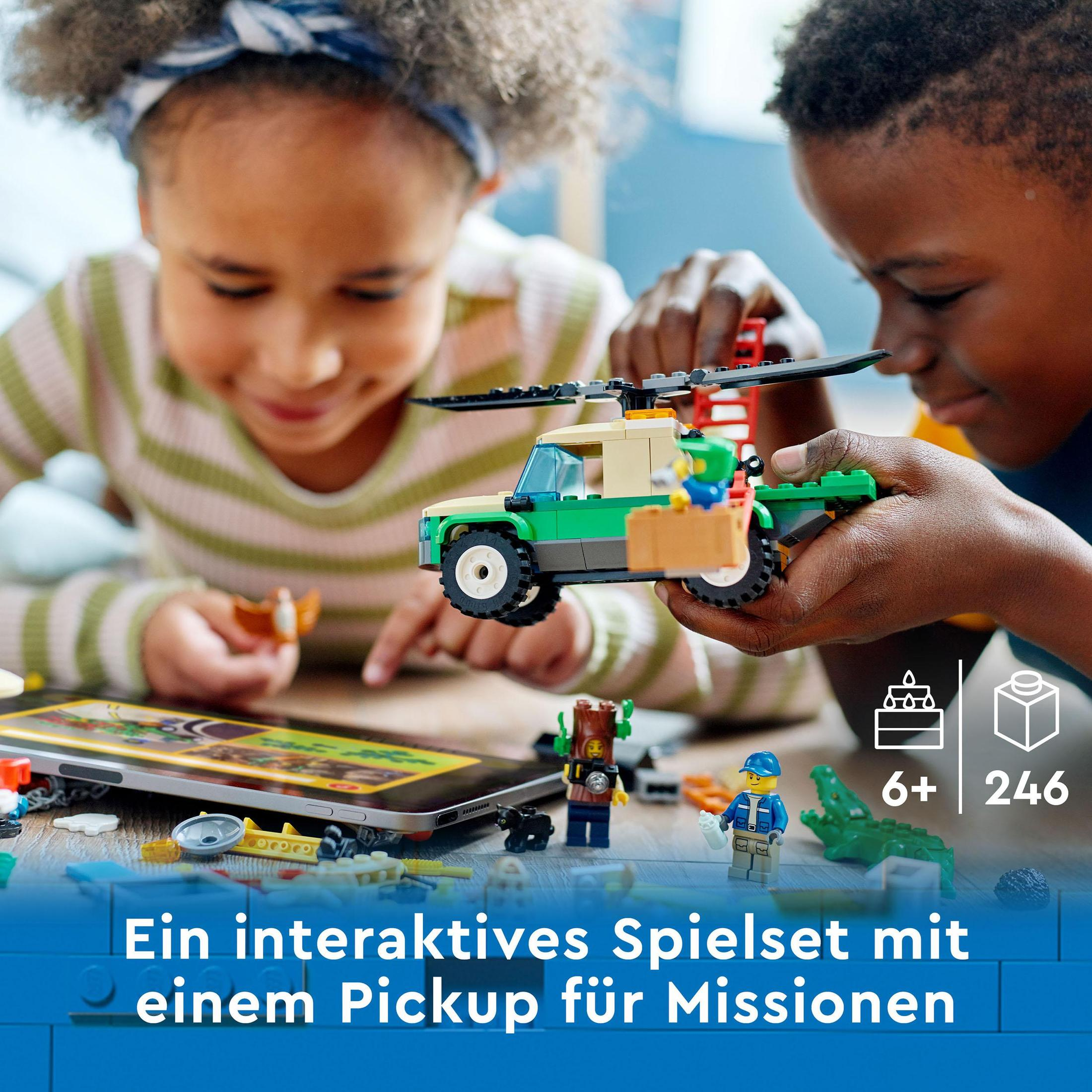 Kinder spielen mit Lego-Steinen und bauen einen grünen Truck.