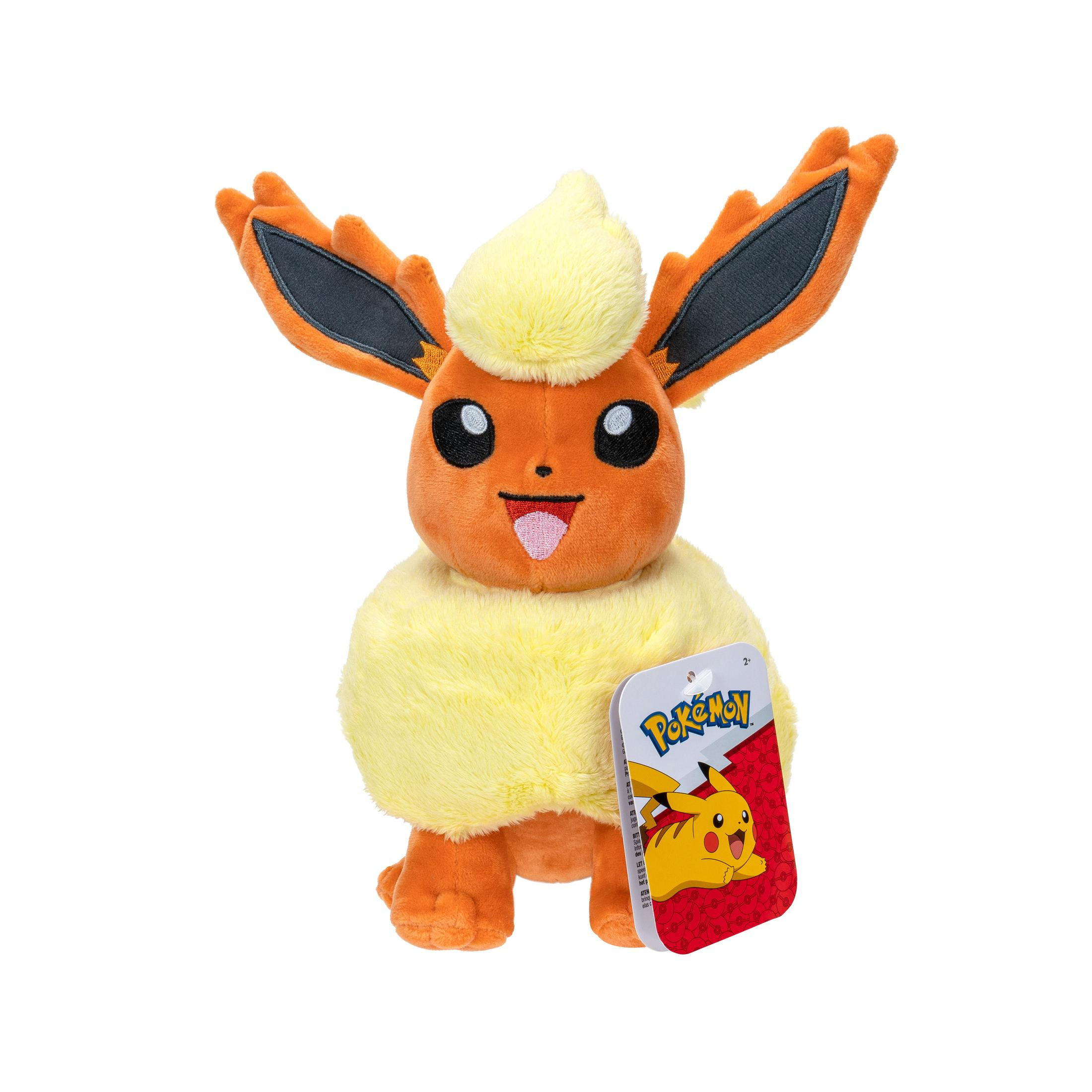 Ein Flareon-Plüschtier mit orangefarbenem Fell und einem gelben Kopf, rotes Pokémon-Etikett.