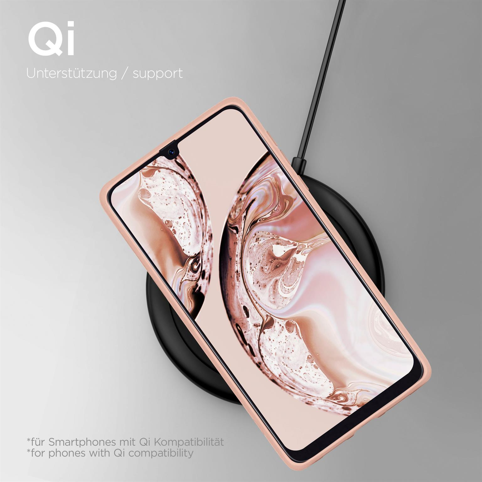 Telefon auf kabellosem Ladegerät. Das Telefon ist rosa und das Ladegerät schwarz.