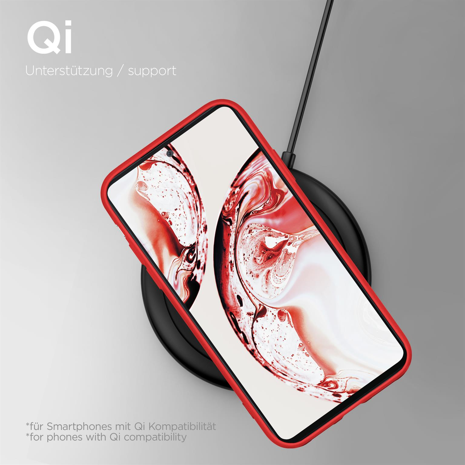 Ein Telefon mit roter Hülle liegt auf einem schwarzen kabellosen Ladegerät. Der Bildschirm hat ein rotes Muster.