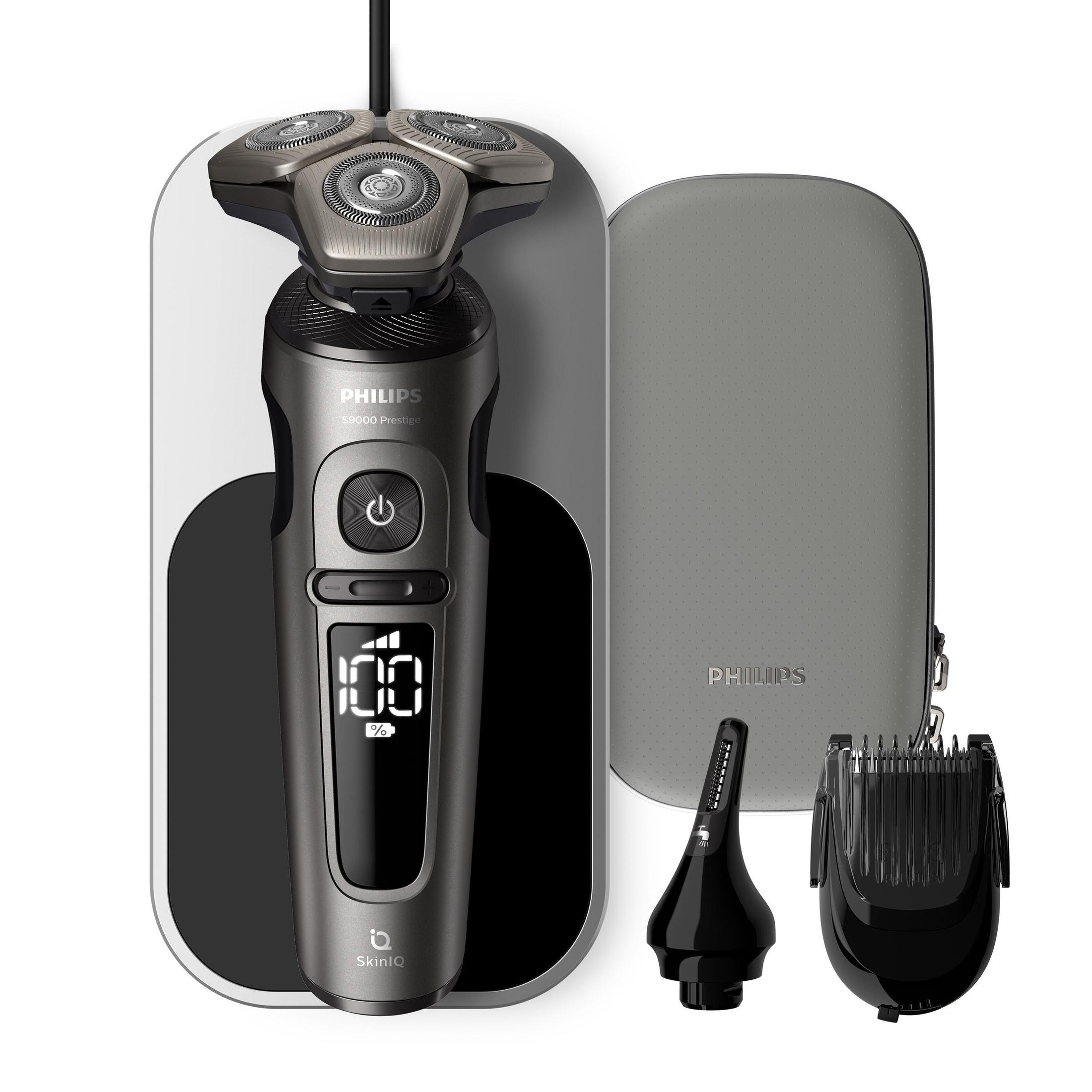 Beyaz bir yüzey üzerinde aksesuarlı bir Philips tıraş makinesi. Koyu gri renktedir.