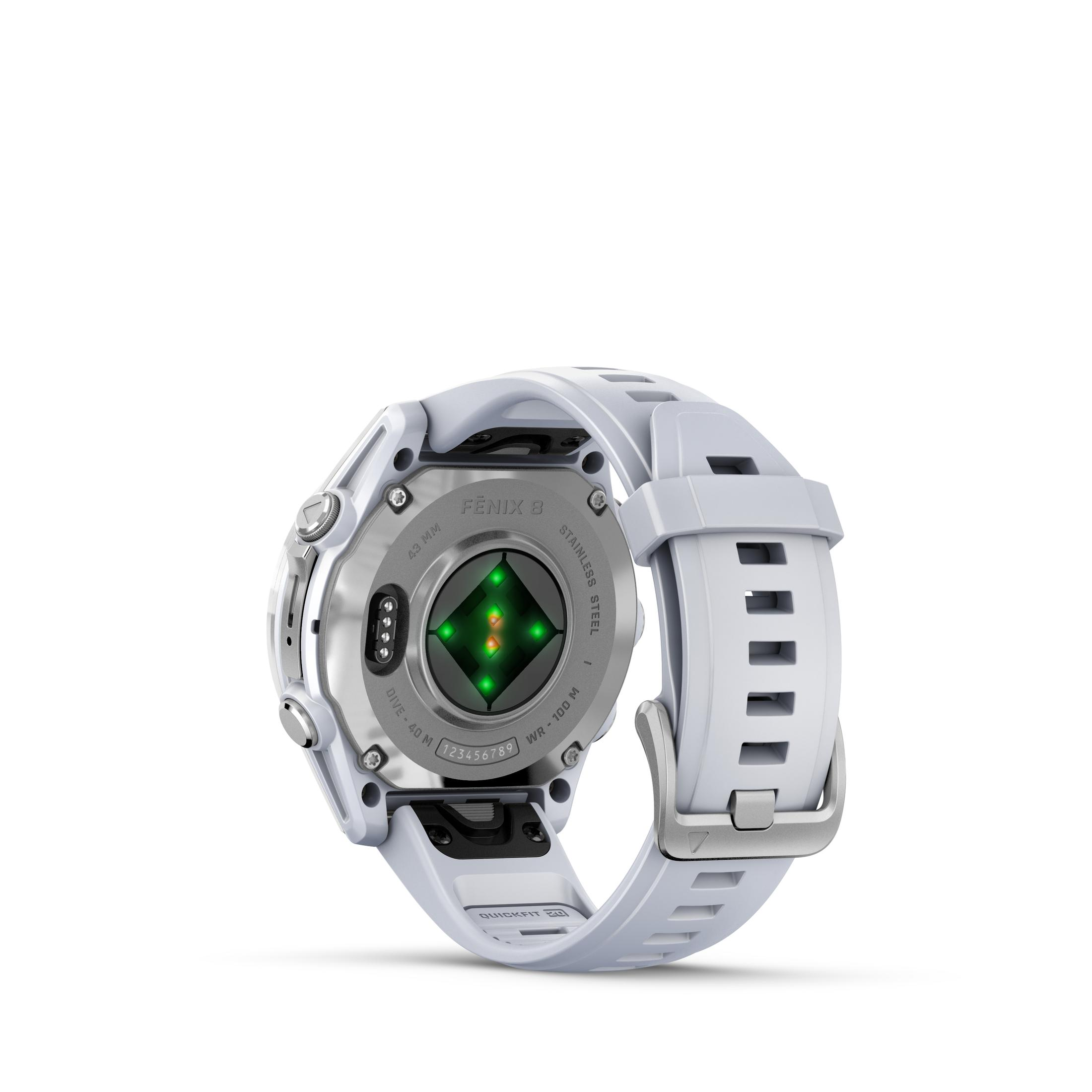 Tył białego zegarka Garmin Fenix 6. Pokazuje czujnik tętna, piny ładowania i pasek.