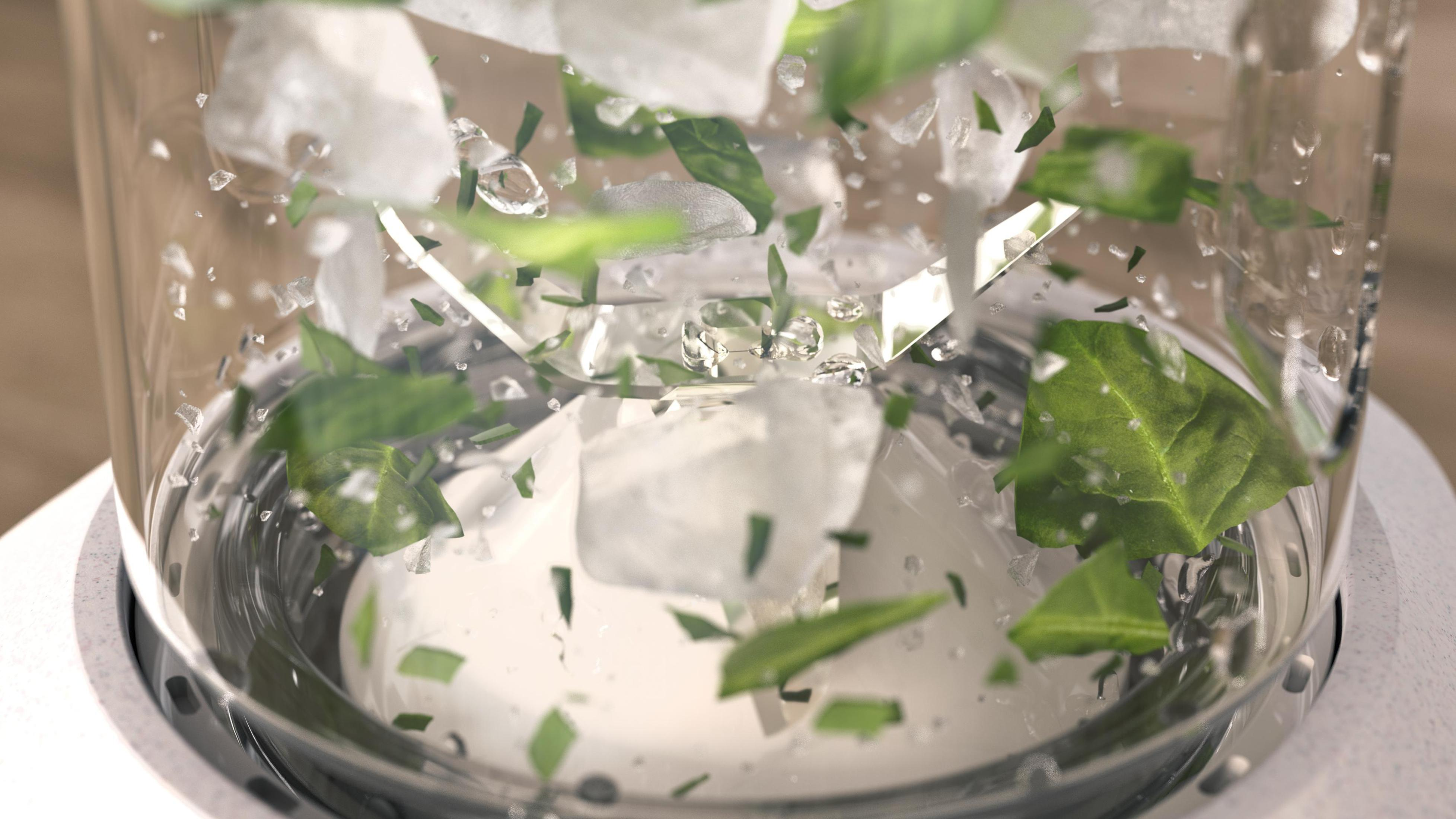 Mixer mit Eiswürfeln, grünen Blättern und Wasser. Bewegungsunschärfe-Effekt.