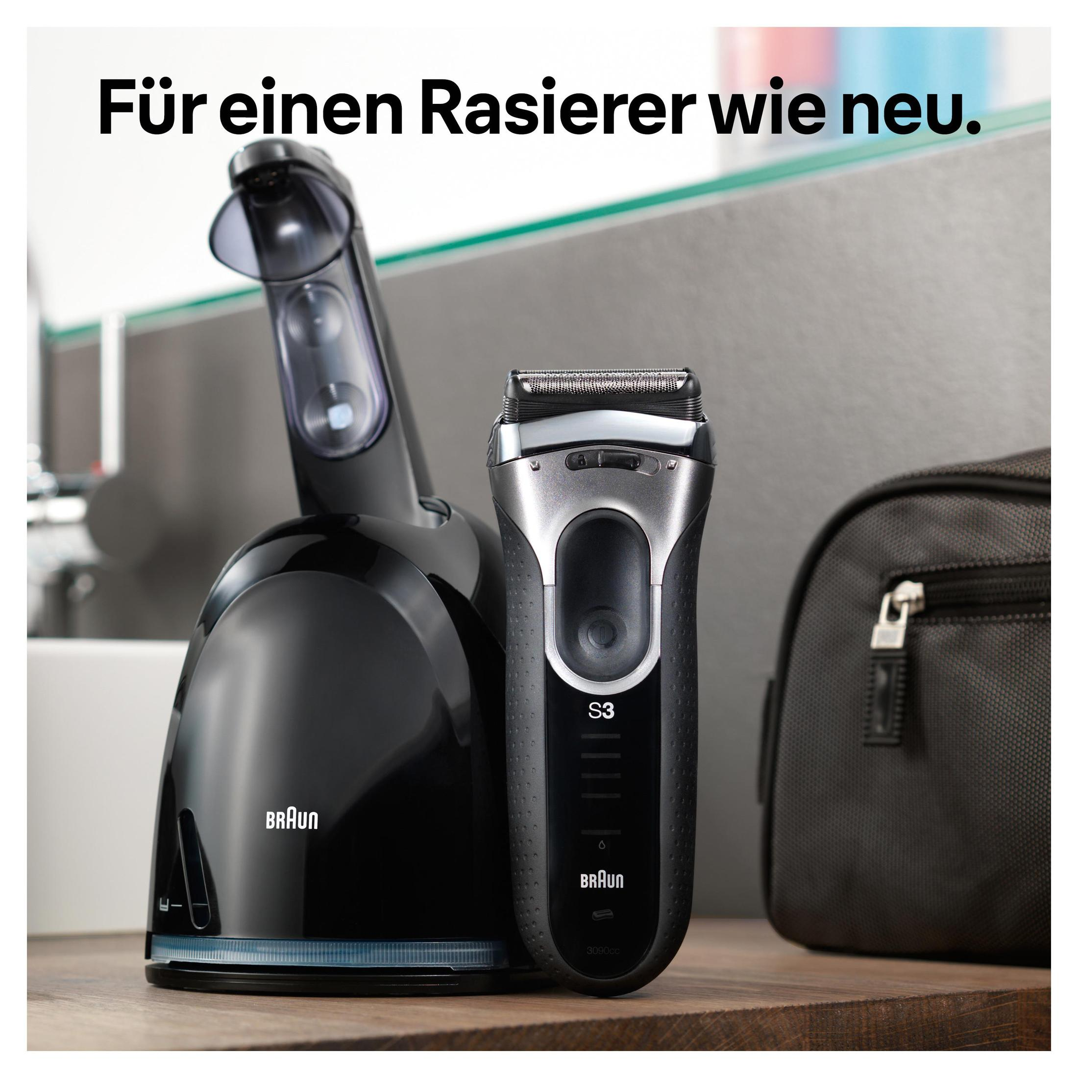Czarna golarka na stacji ładującej, z czarną torbą. Tekst: 'Für einen Rasierer wie neu.'