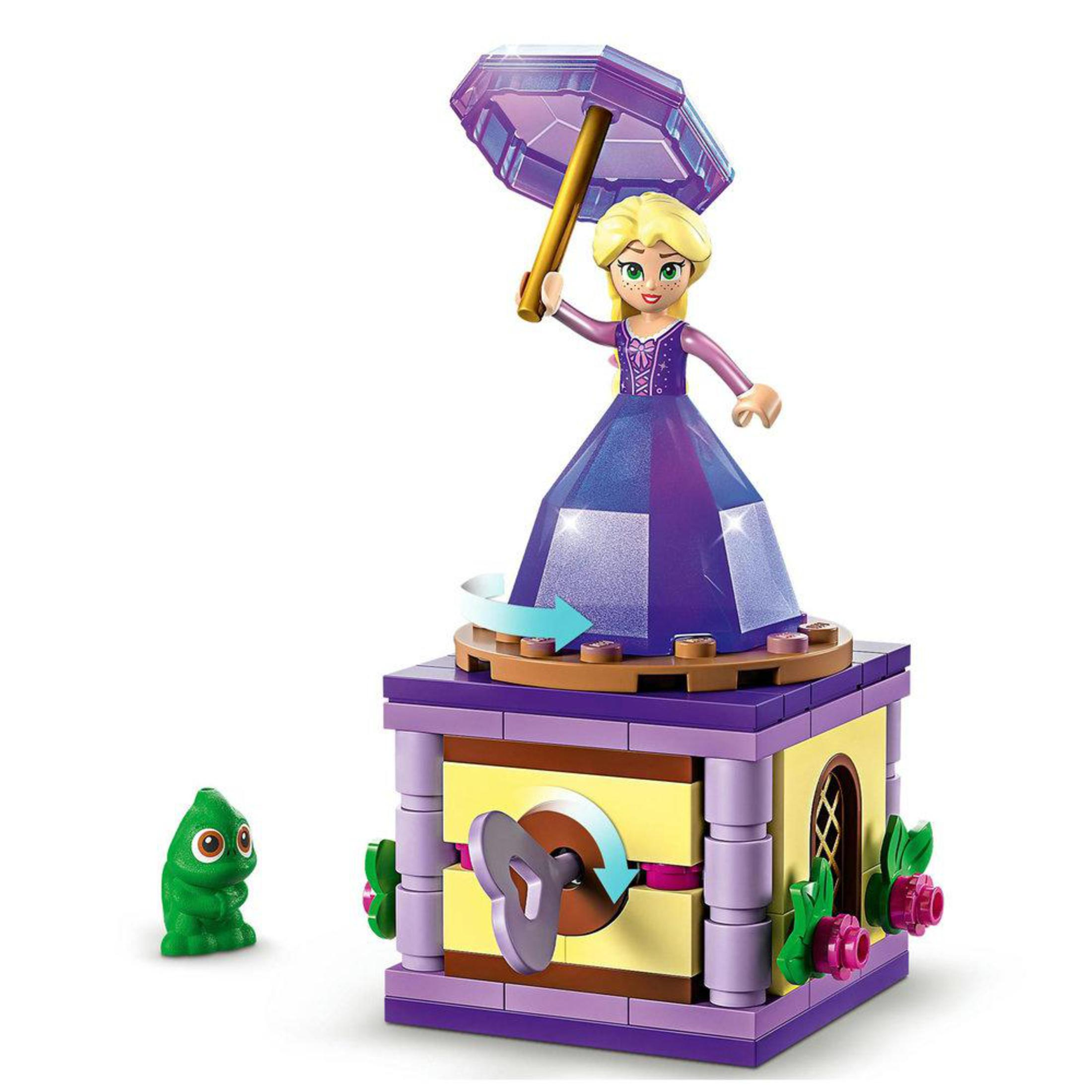 Lego-Set: Prinzessin mit Schirm auf rotierender Plattform, grüner Drache und gelbe Struktur.