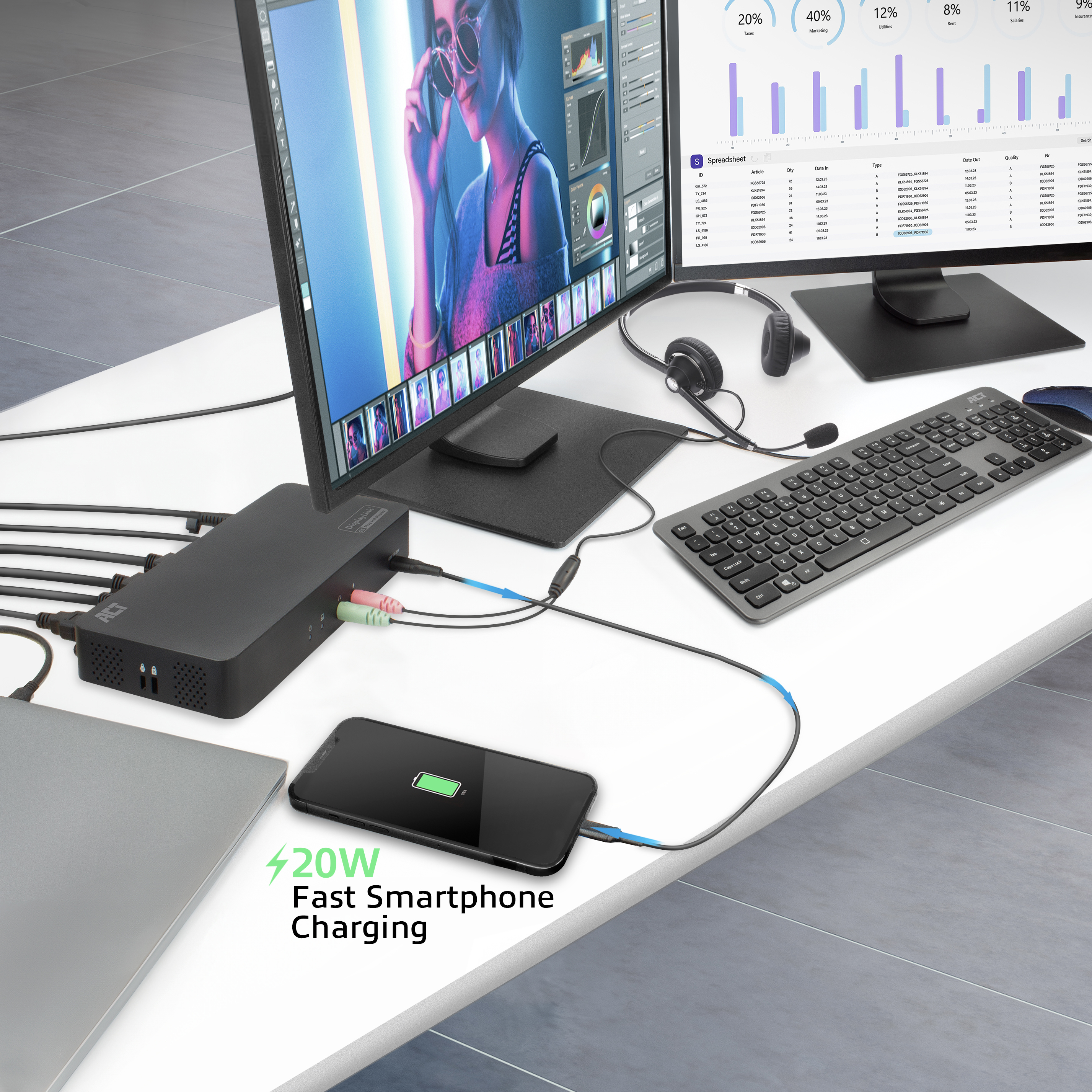 Schreibtisch-Setup mit Monitor, Tastatur, Telefonaufladung und einem schwarzen Hub.