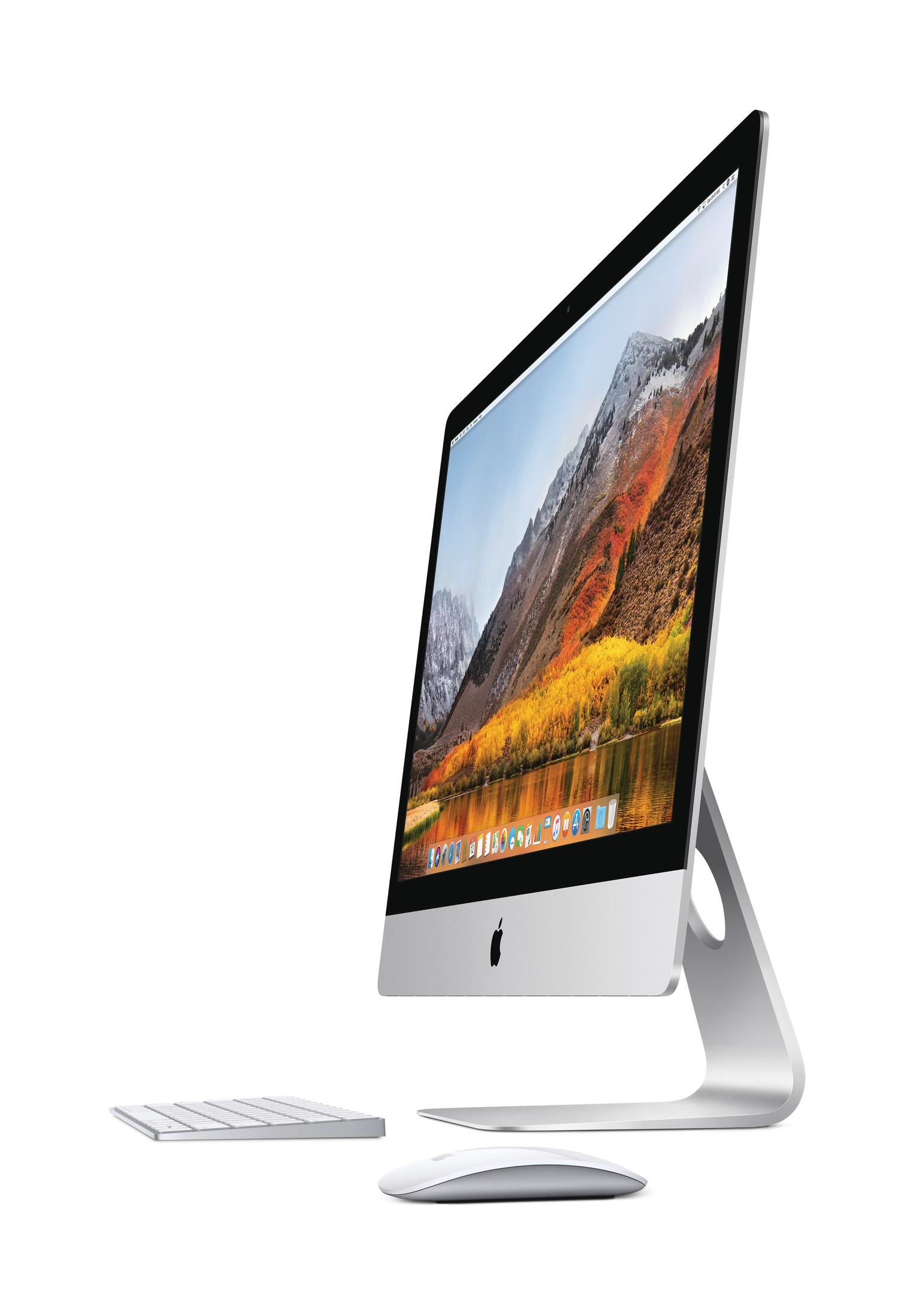Ein iMac-Computer mit Tastatur und Maus davor. Der Bildschirm zeigt eine Berglandschaft.