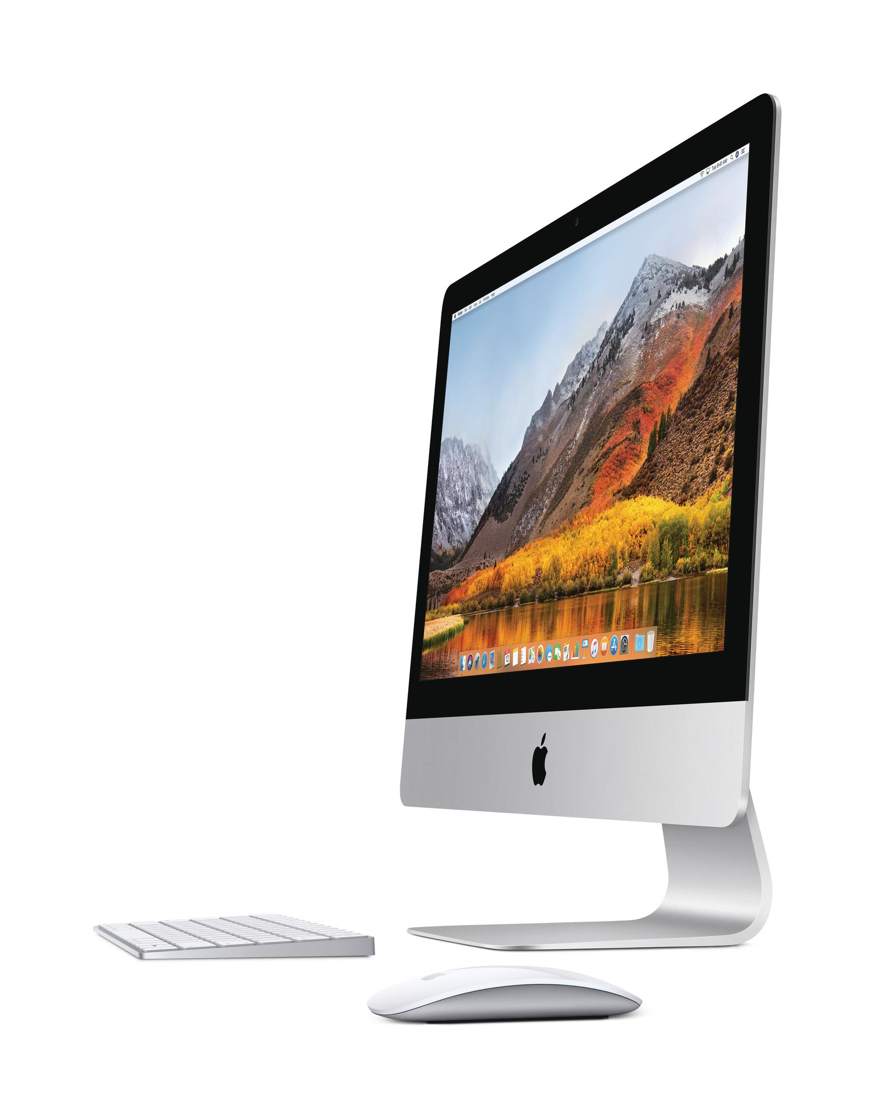 Ein iMac mit Tastatur und Maus, der eine Berglandschaft auf dem Bildschirm zeigt.