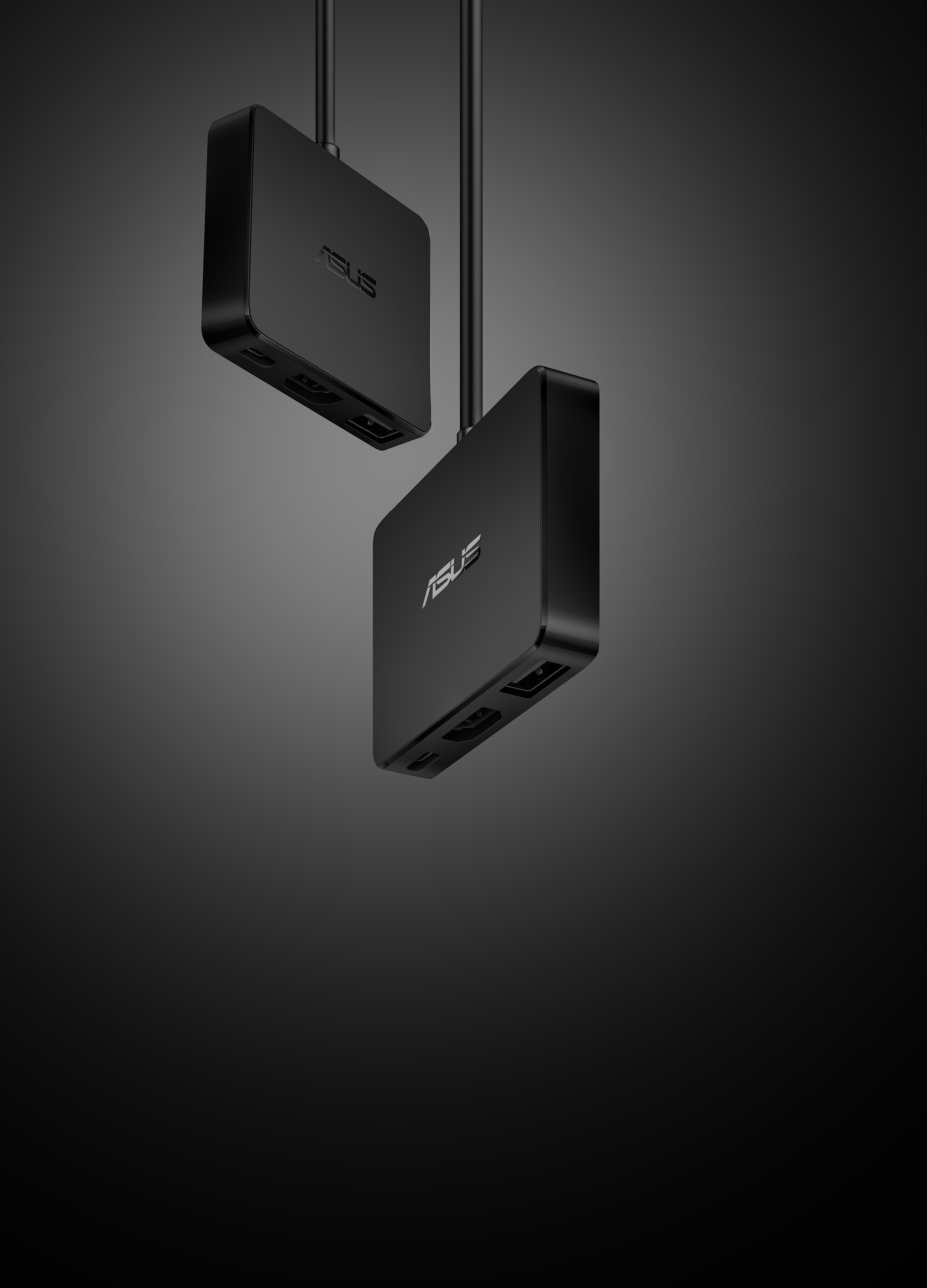 Two black ASUS USB hubs with cables, against a dark background.