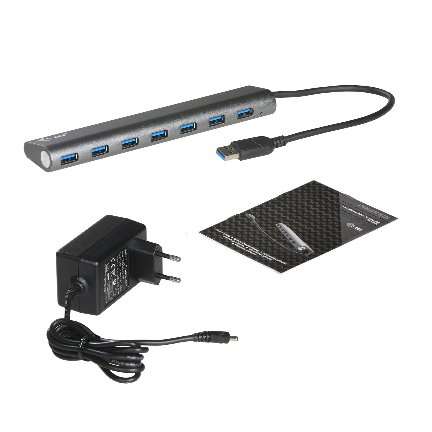 Hub USB, adaptateur secteur et feuille d'instructions sur fond blanc.