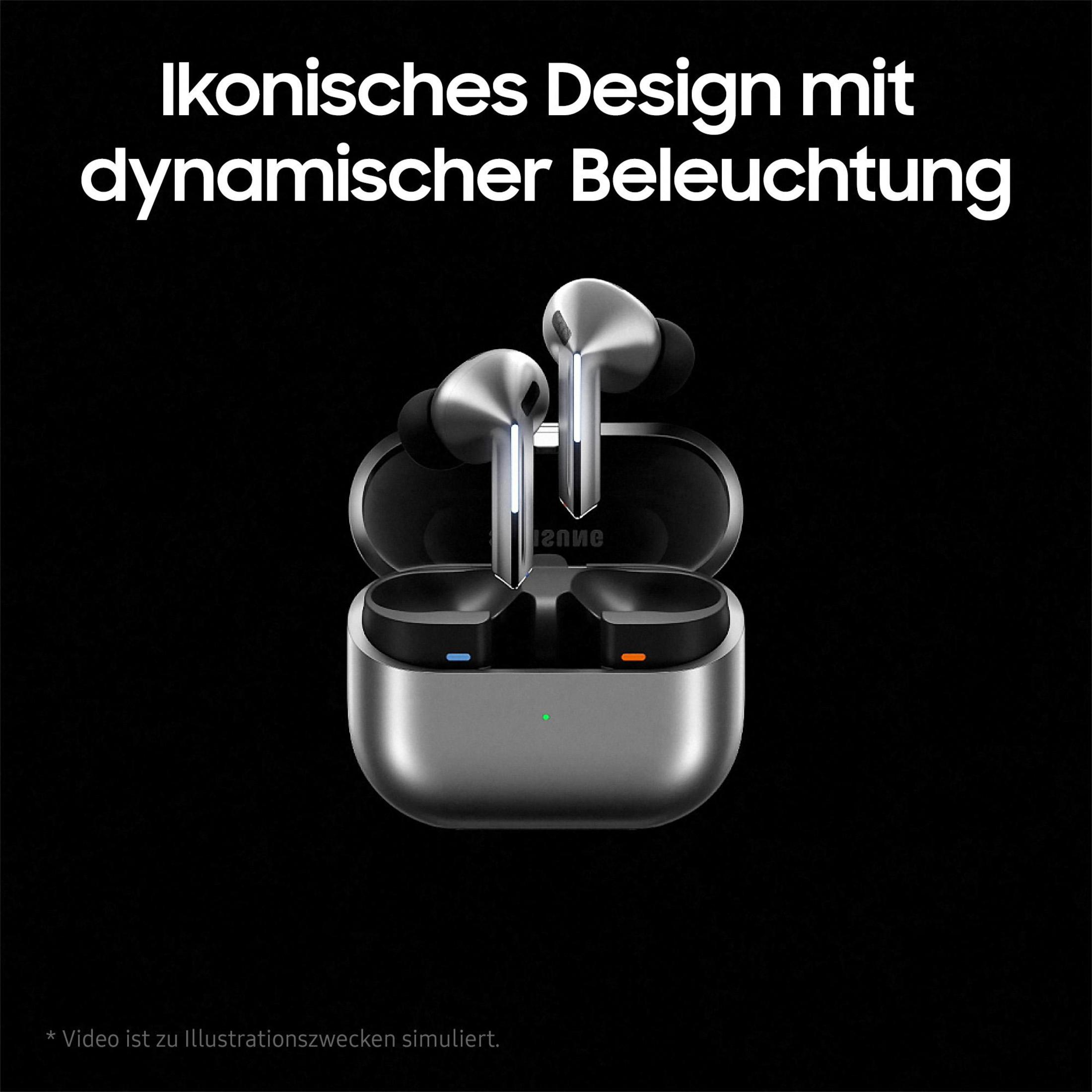 Srebrne słuchawki w etui ładującym na czarnym tle. Tekst nad nimi po niemiecku.