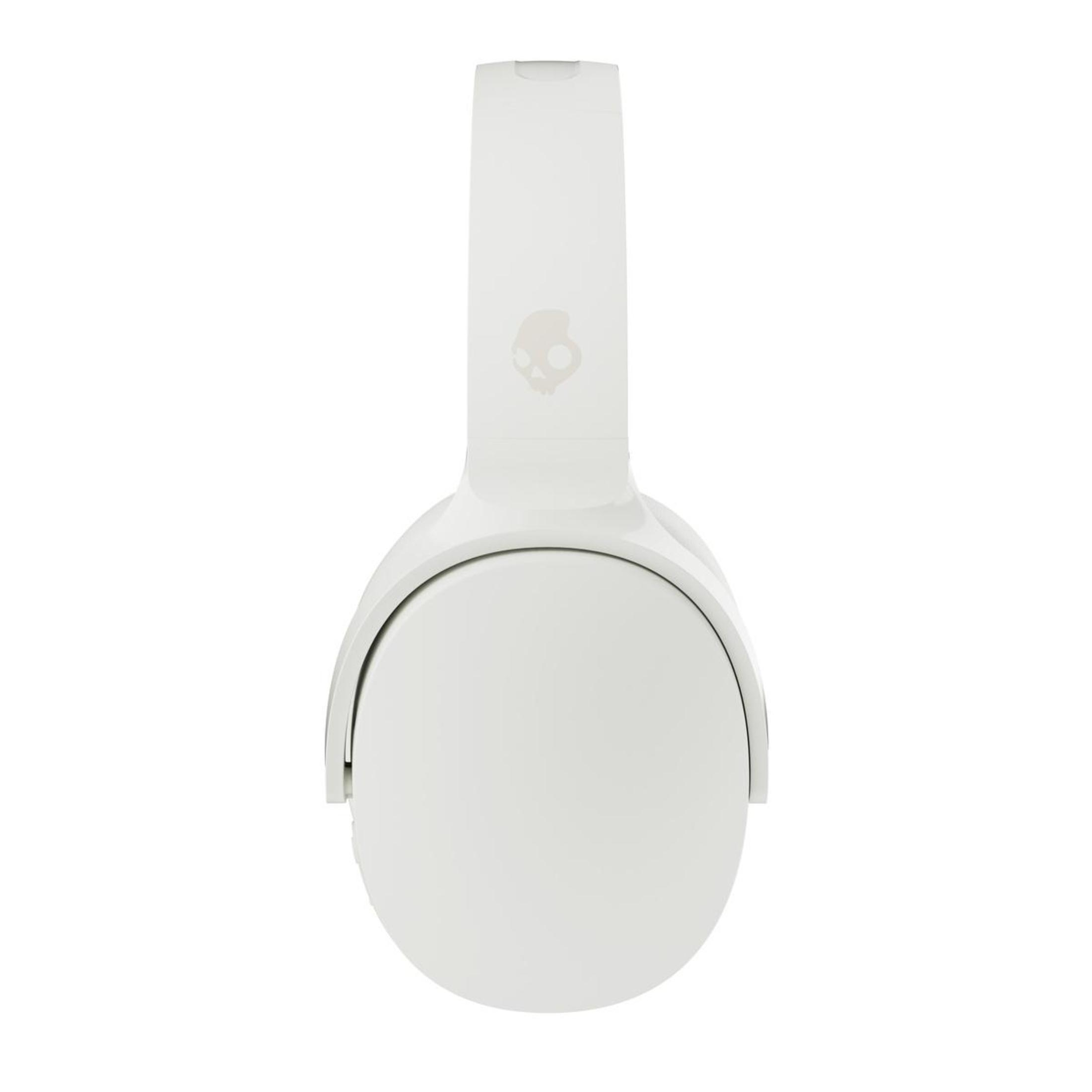 White headphones with a skull logo on the side. Top view.