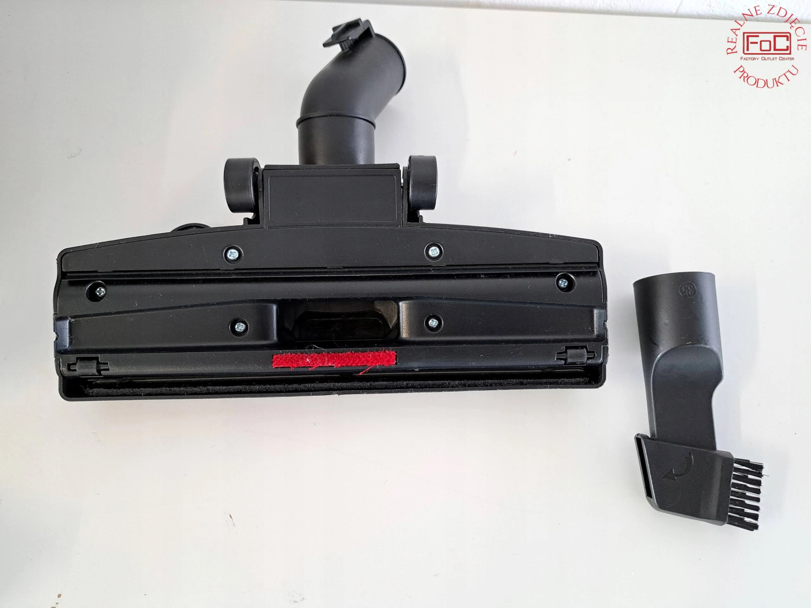 Czarna głowica odkurzacza i szczotka.