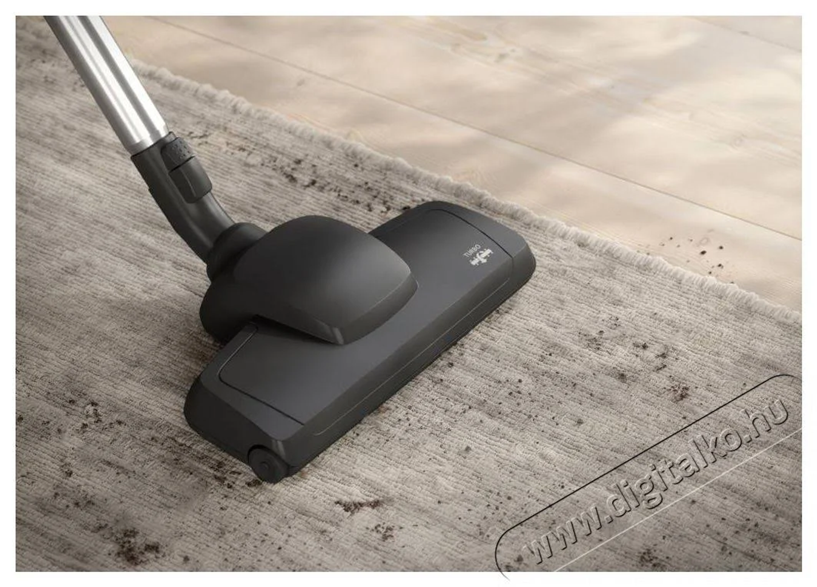 A vacuum cleaner head cleaning a rug with visible dirt.
