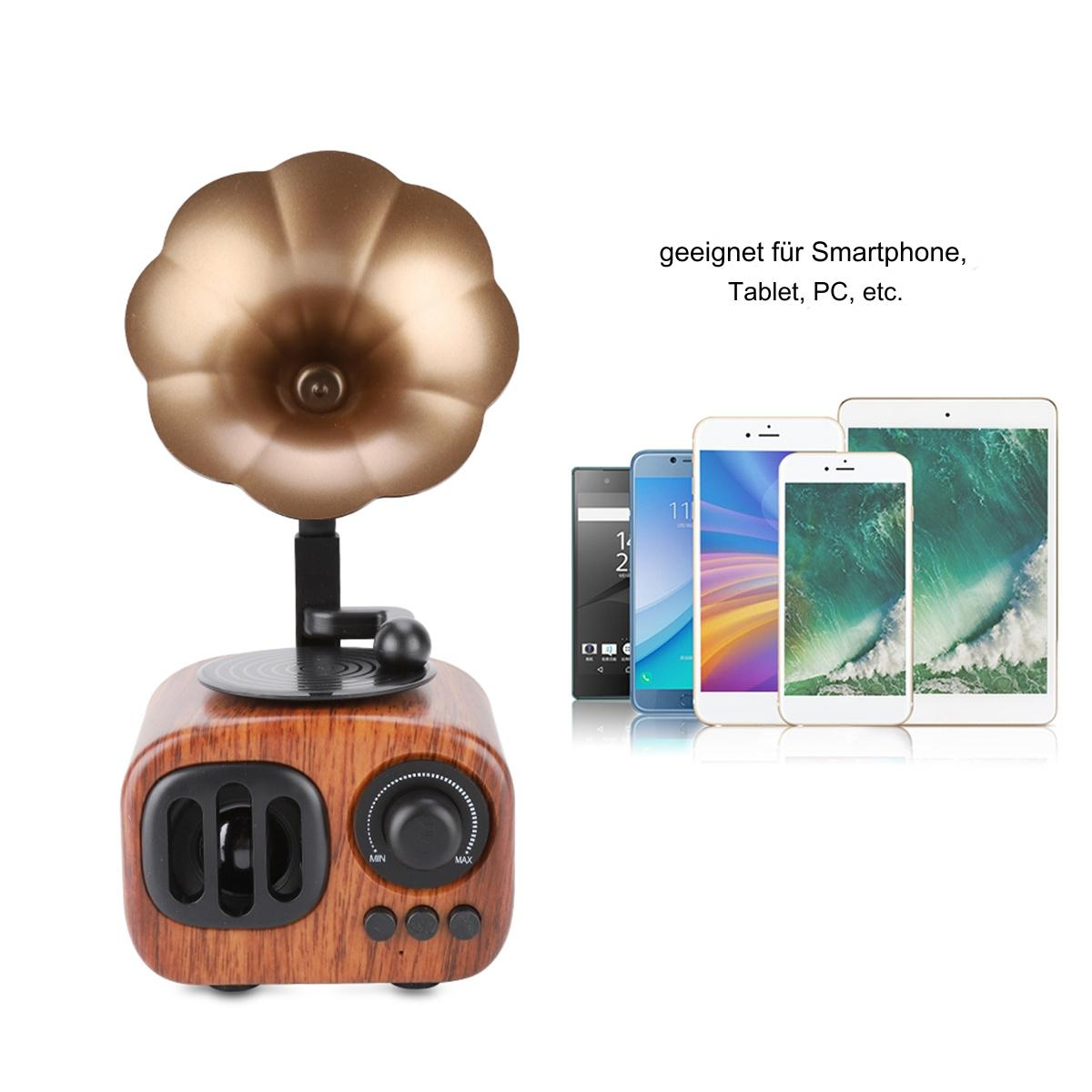 Vintage Grammophon-Lautsprecher, mit einigen Smartphones und einem Tablet daneben.