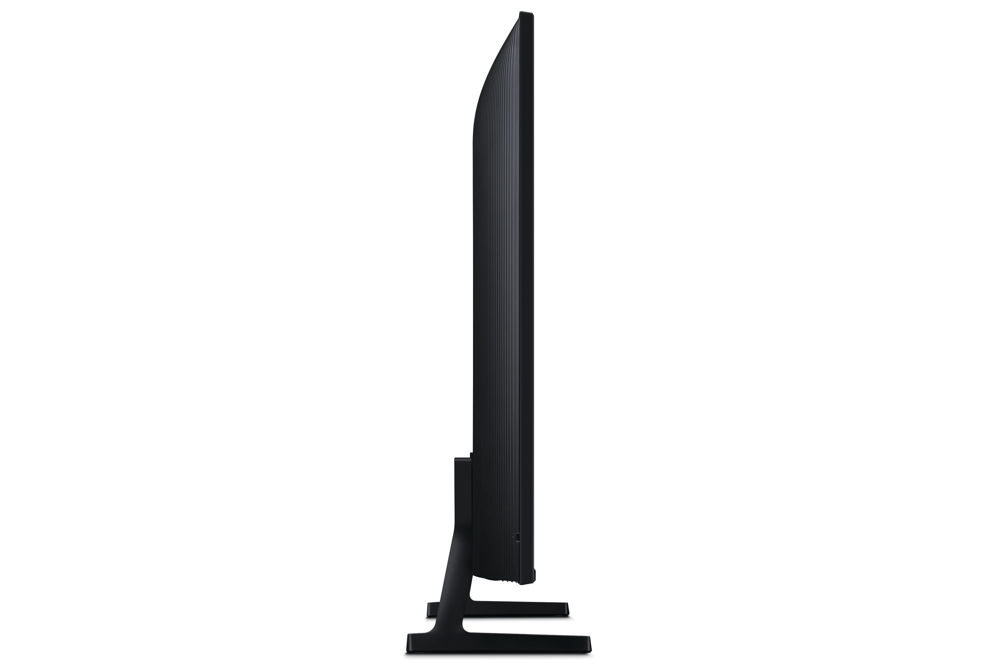 Widok z boku czarnego telewizora. Czarna podstawa. Białe tło.