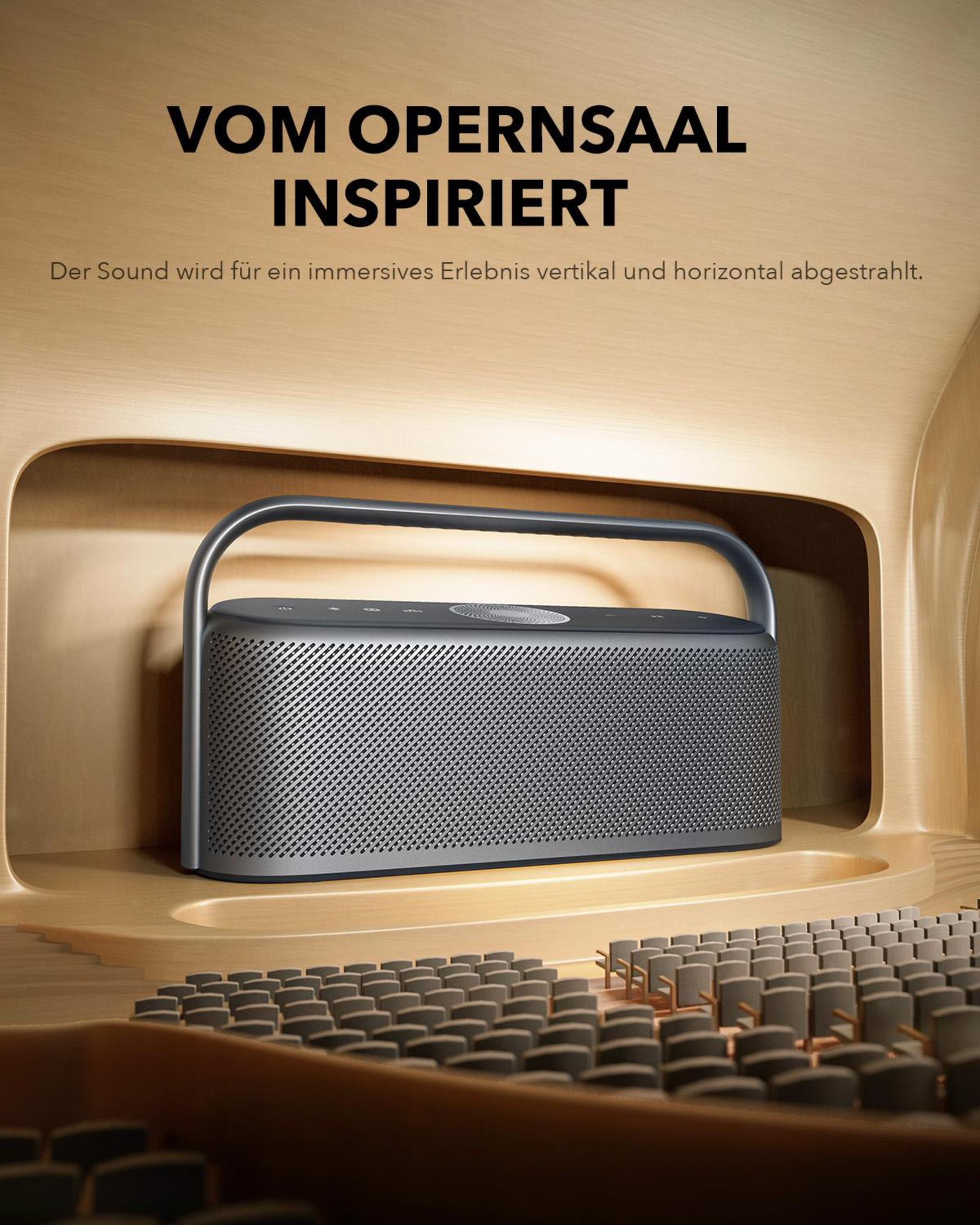 Ciemnoszary głośnik w drewnianej konstrukcji, z tekstem nad nim.