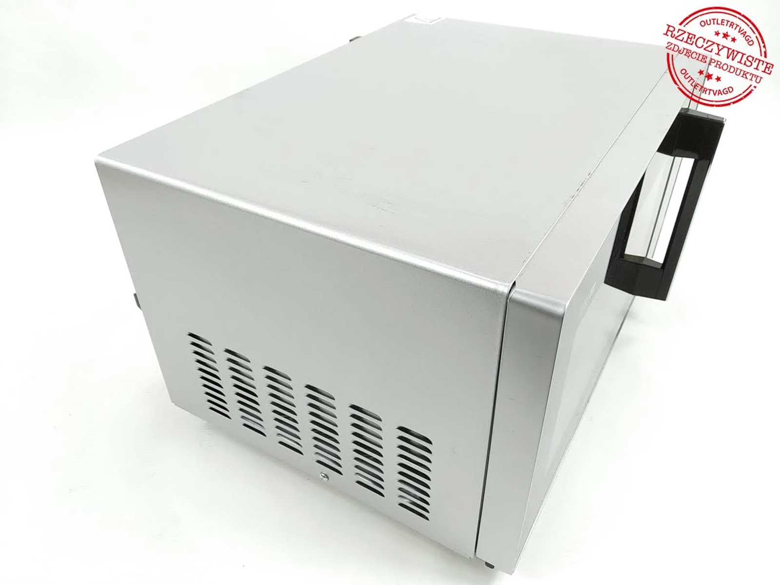 Srebrna kuchenka mikrofalowa jest pokazana z góry, z otworami wentylacyjnymi z boku.