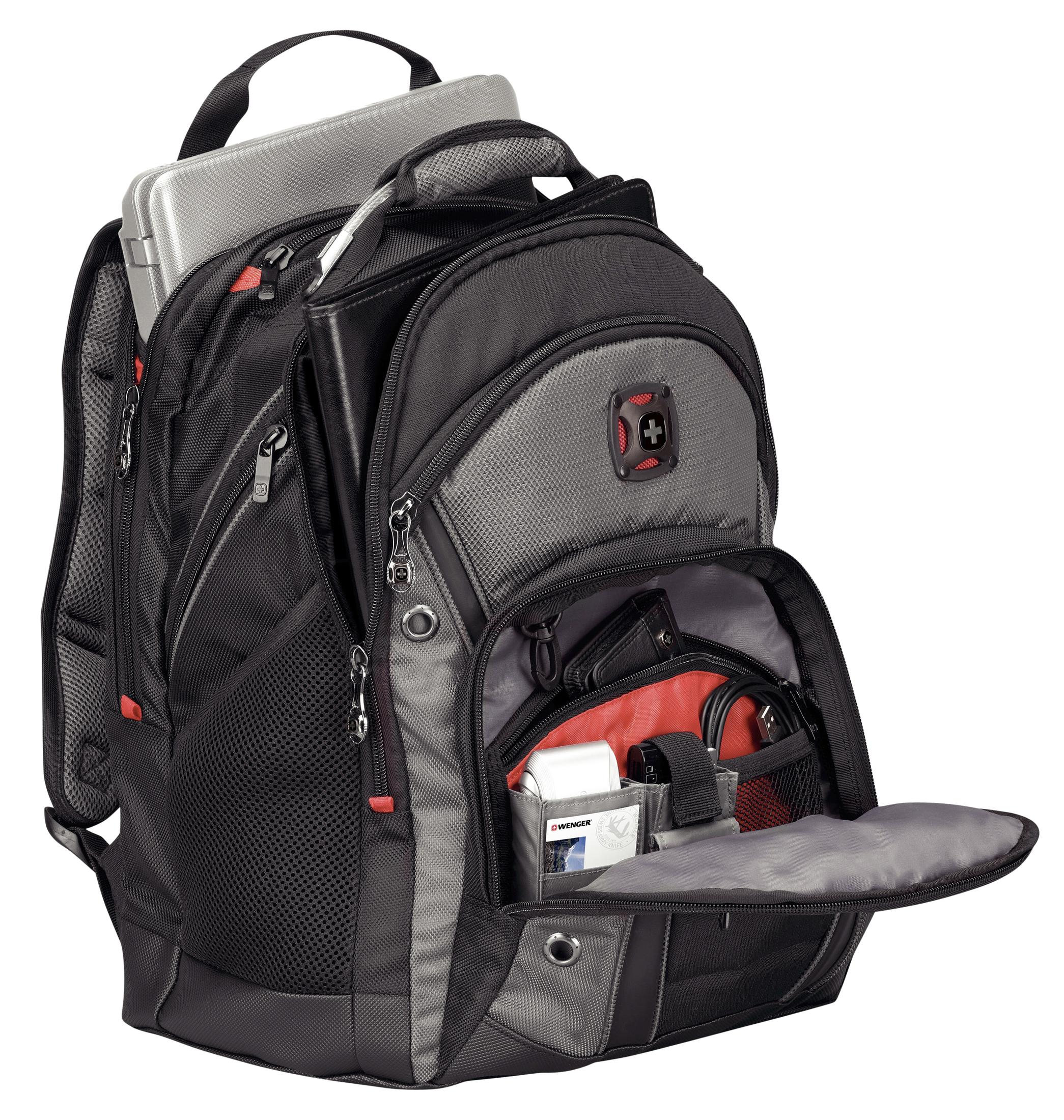 Sac à dos noir et gris, ouvert, montrant les compartiments intérieurs et les objets.