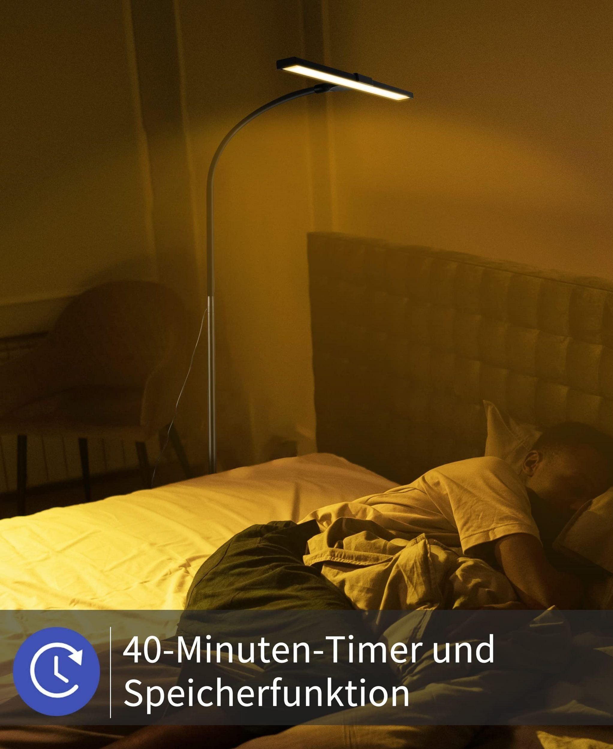 Osoba śpiąca obok lampy podłogowej w pokoju z żółtym światłem.