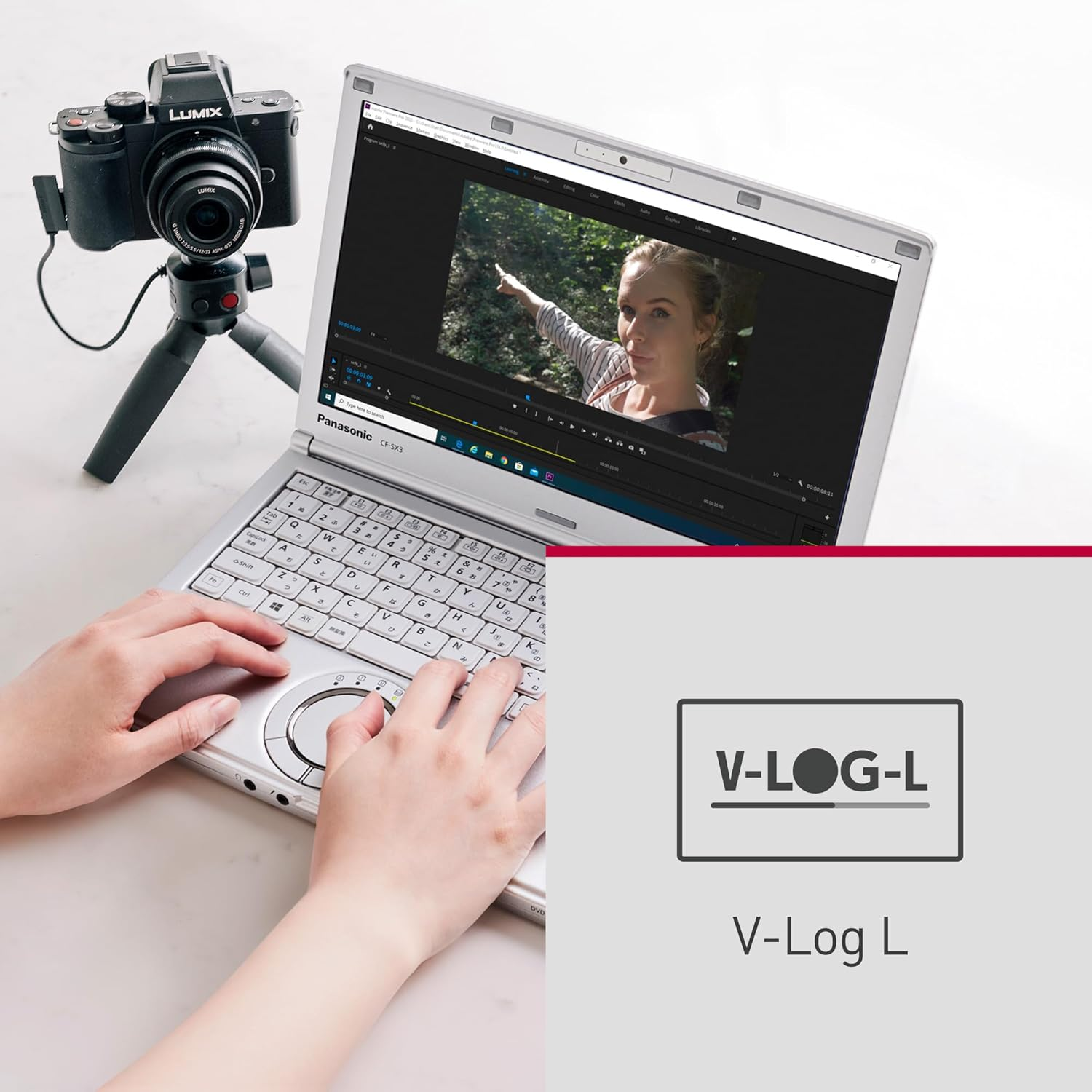Laptop- und Kamera-Setup für Videobearbeitung, eine Frau zeigt auf den Bildschirm.