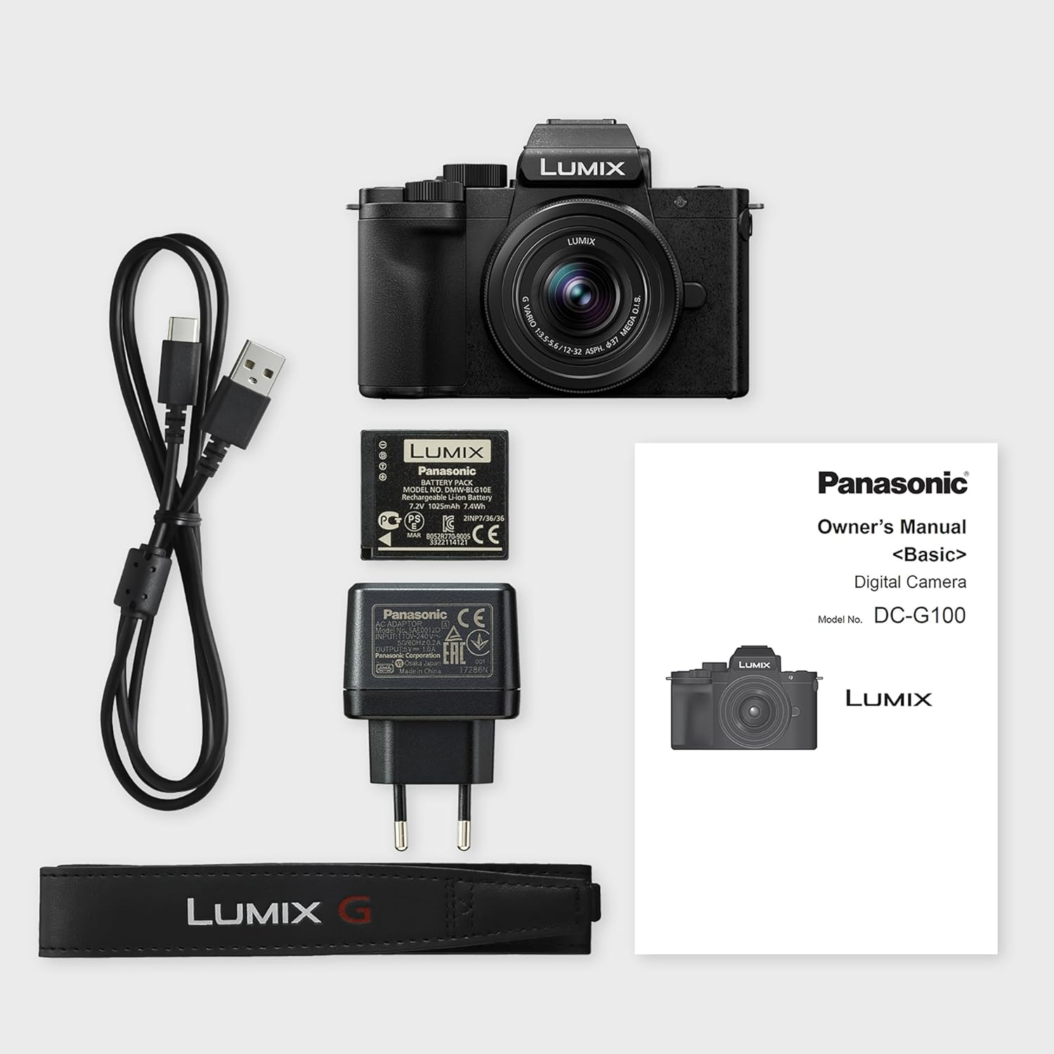 Kamera-Kit mit Kamera, Akku, Ladegerät, Kabel und Zubehör, alles sauber angeordnet.