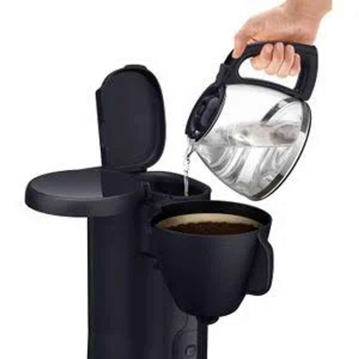 A hand pouring water from a glass carafe into a coffee maker.